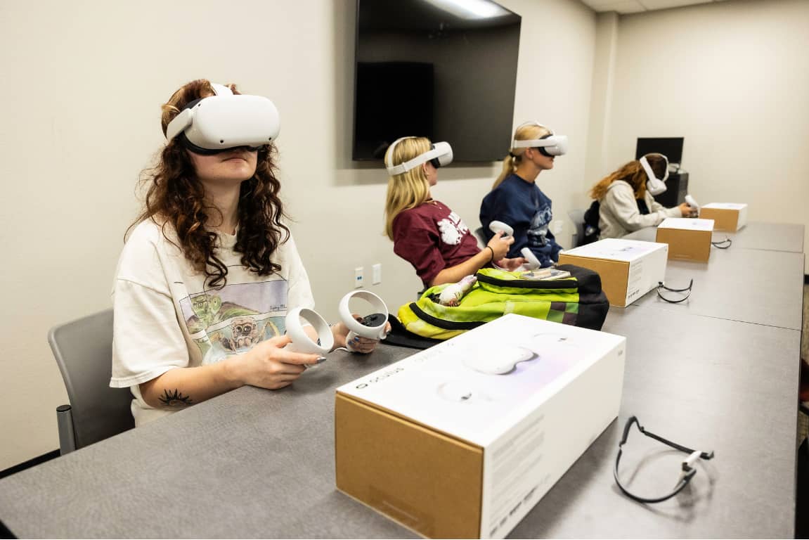 a group of people wearing virtual reality goggles