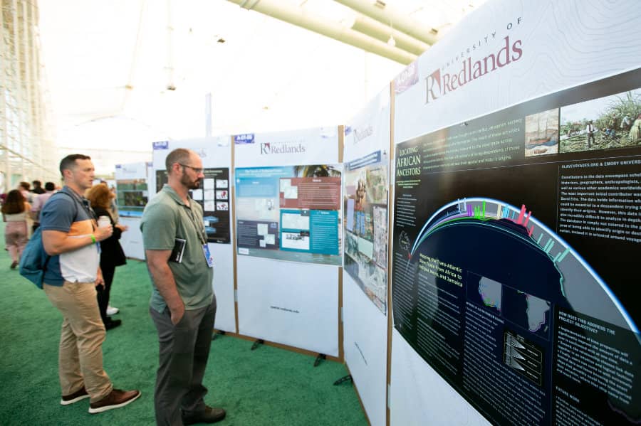 a group of people looking at a poster