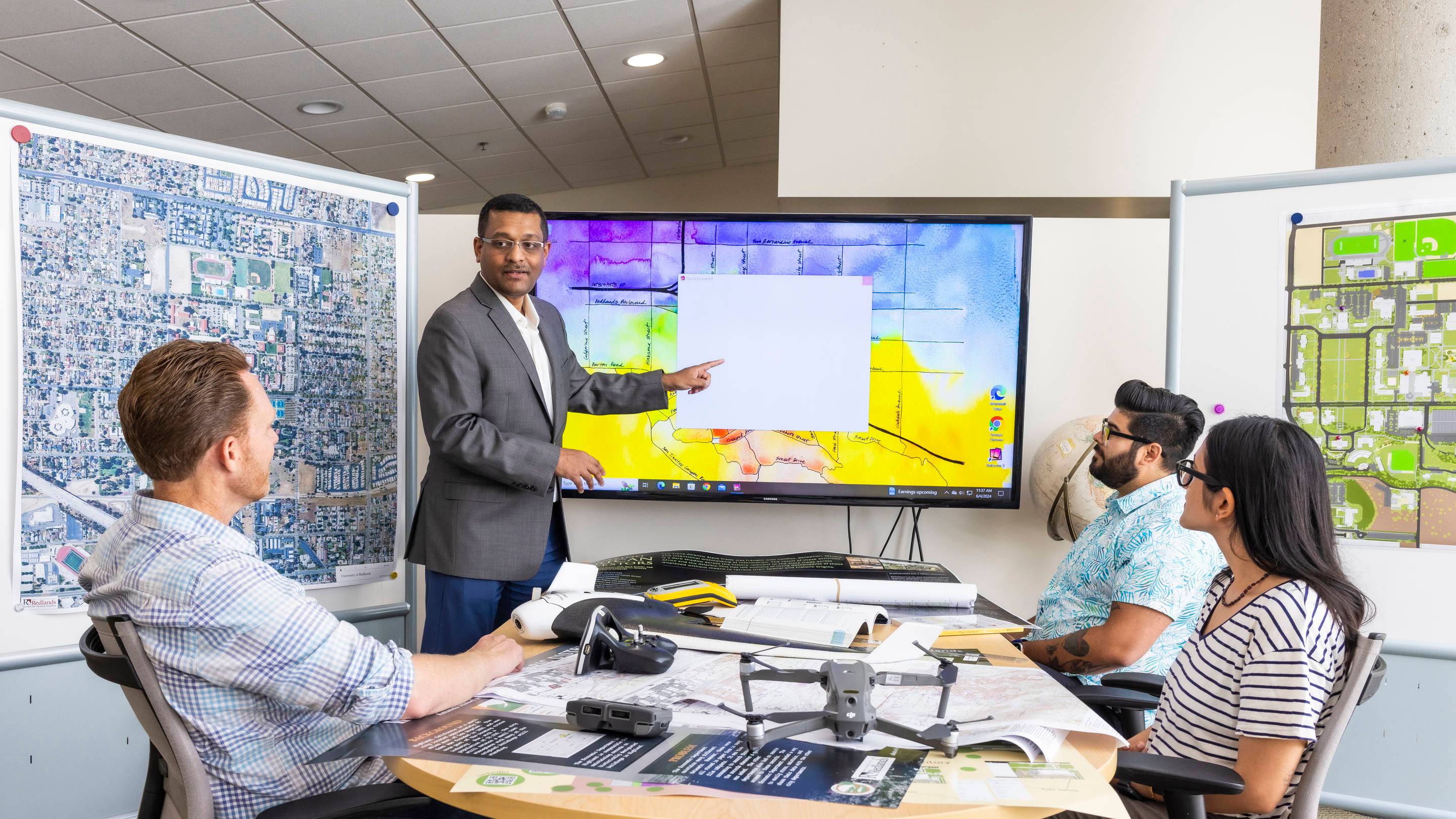 a man pointing at a screen