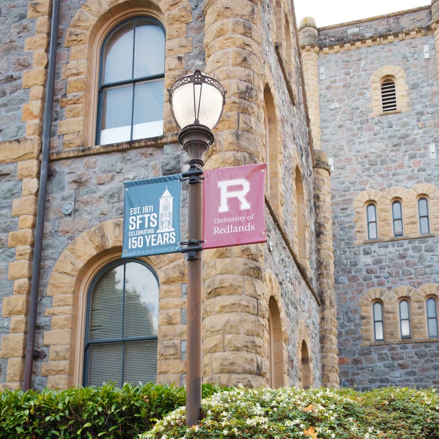 a street light in front of a stone building