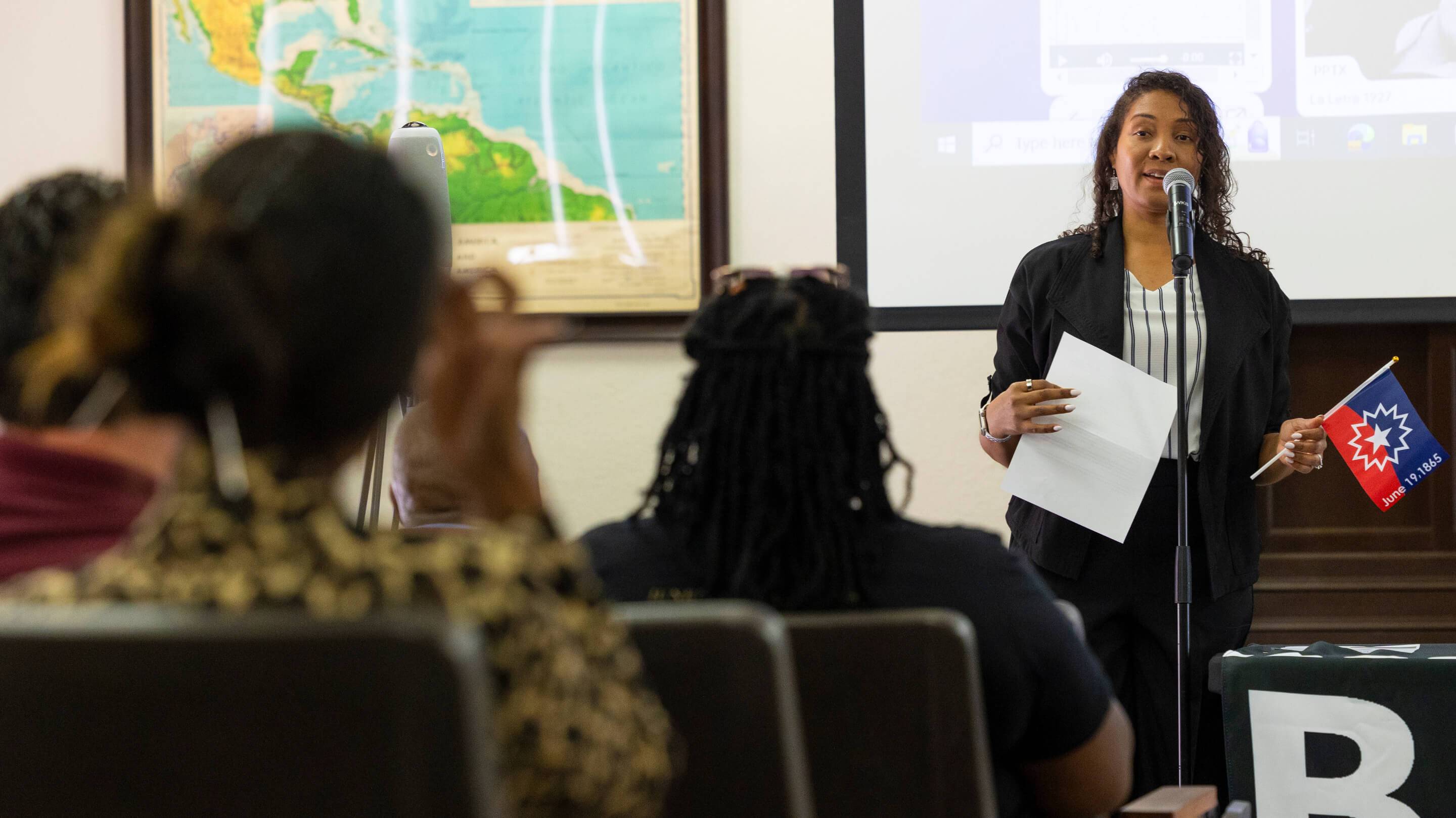 a woman standing in front of a group of people