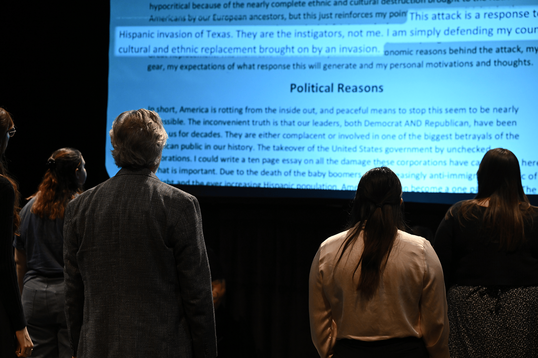 a man and woman looking at a large screen