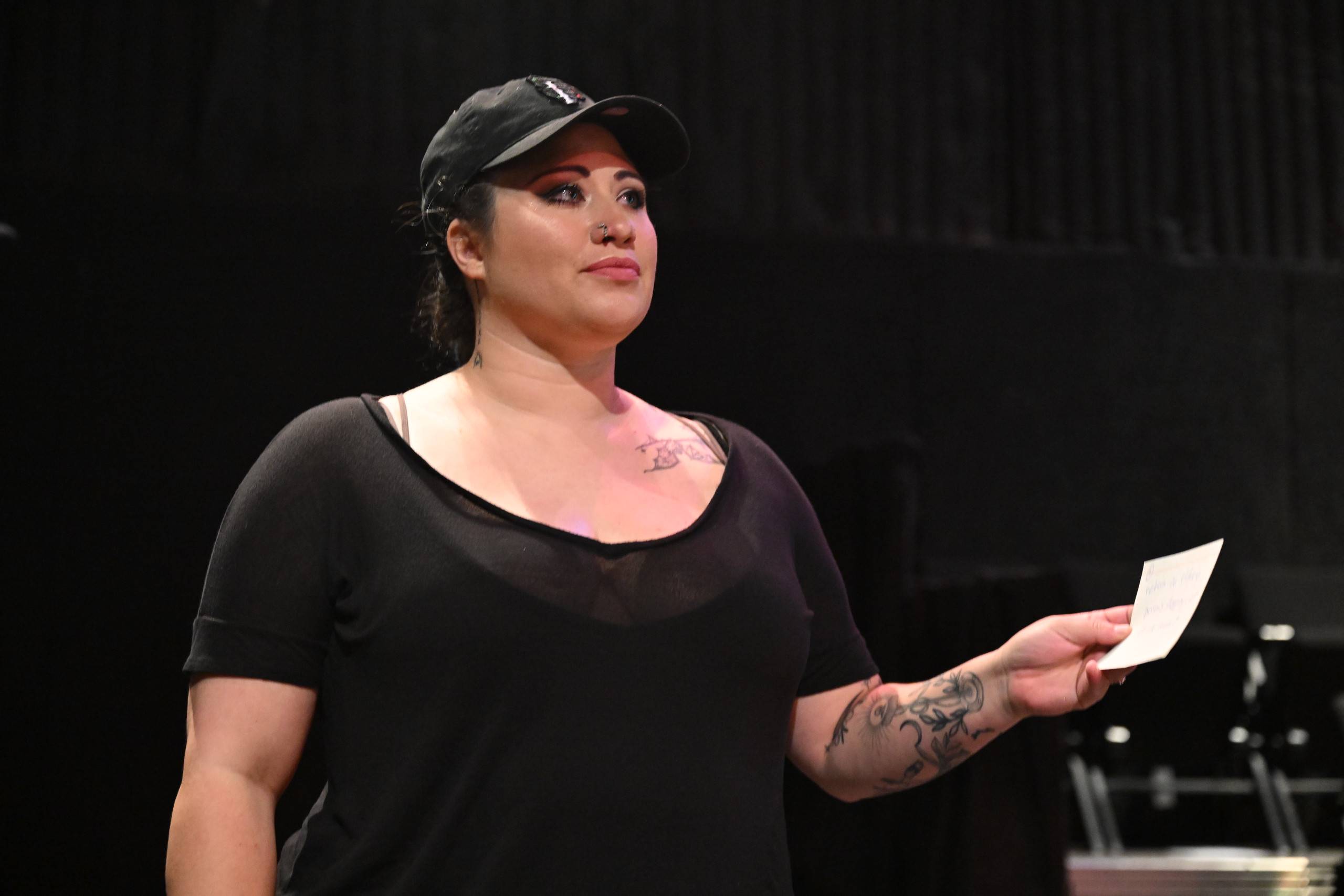 a woman wearing a hat and black shirt