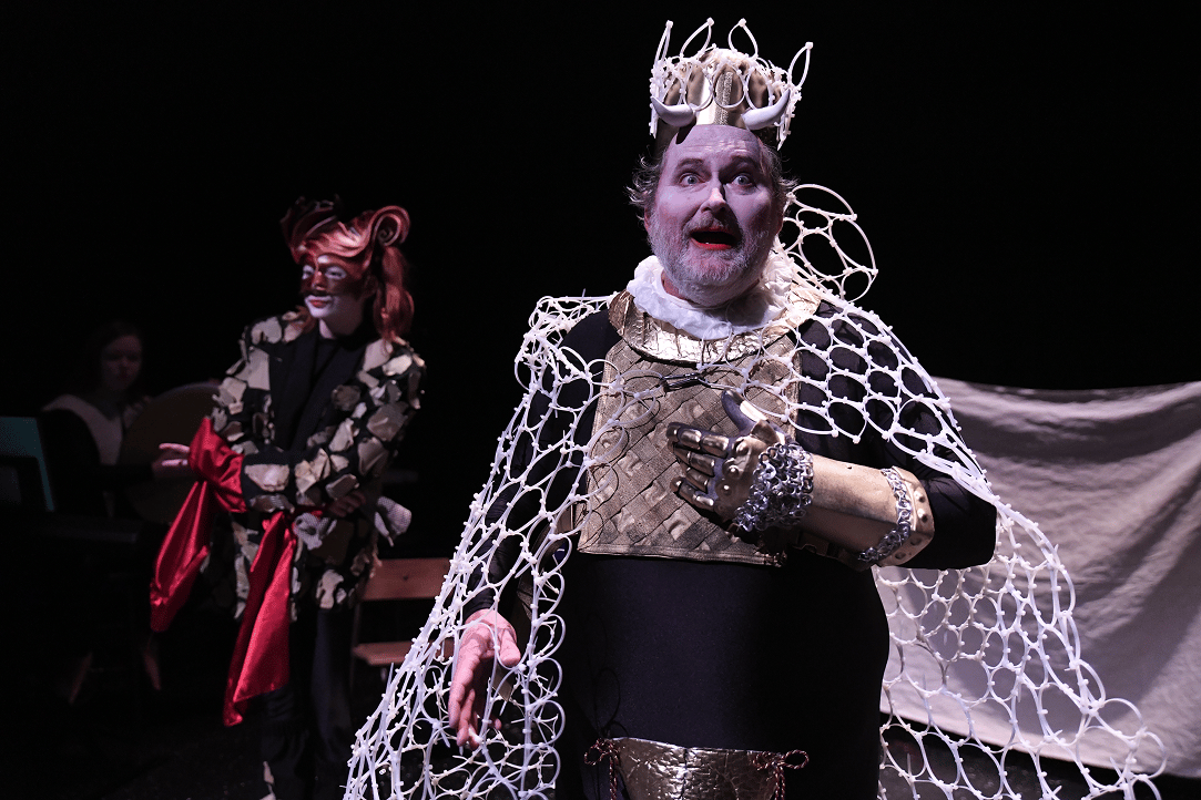 a man in garment with a white net around his neck