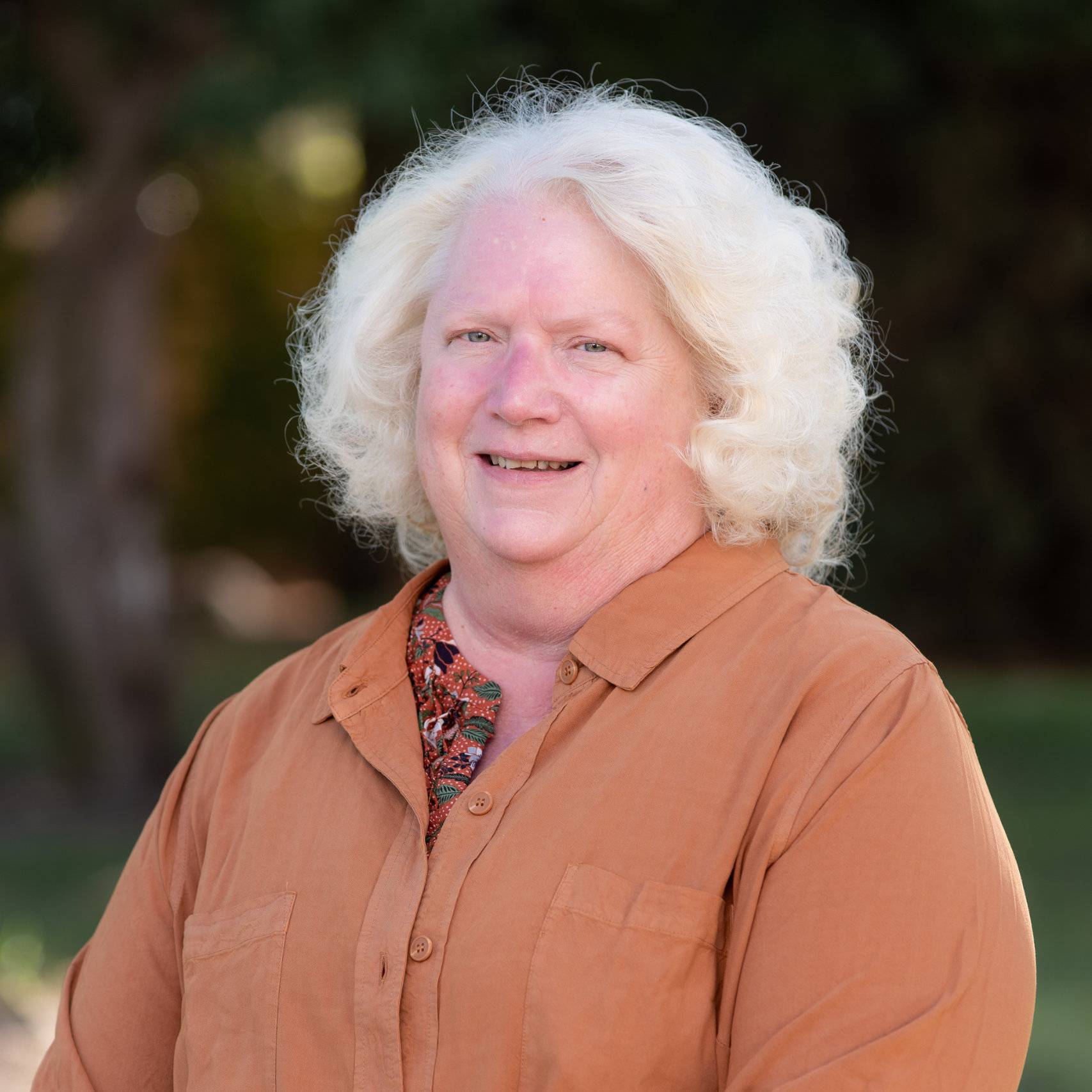 a woman with white hair smiling