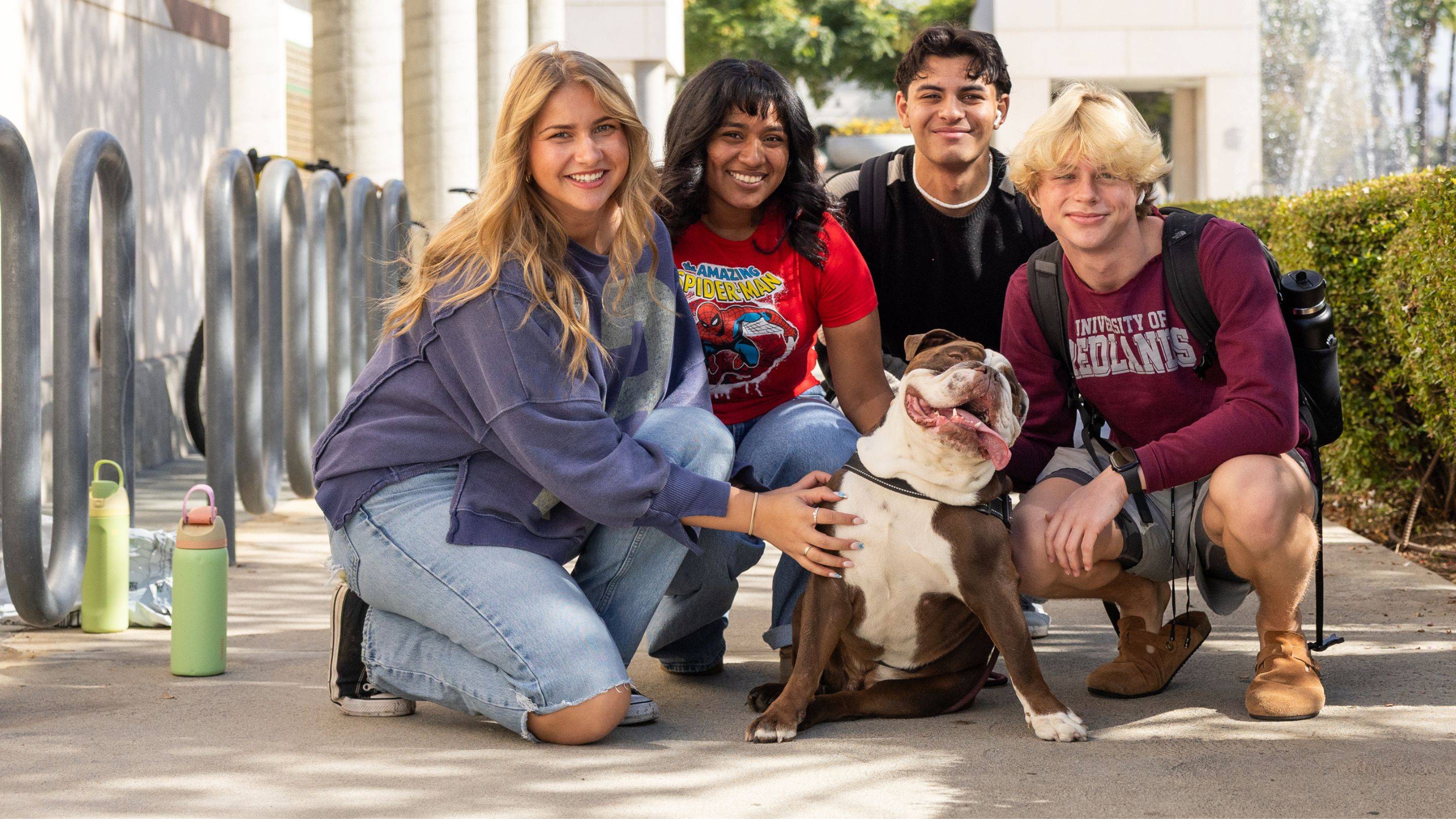 a group of people posing with a dog