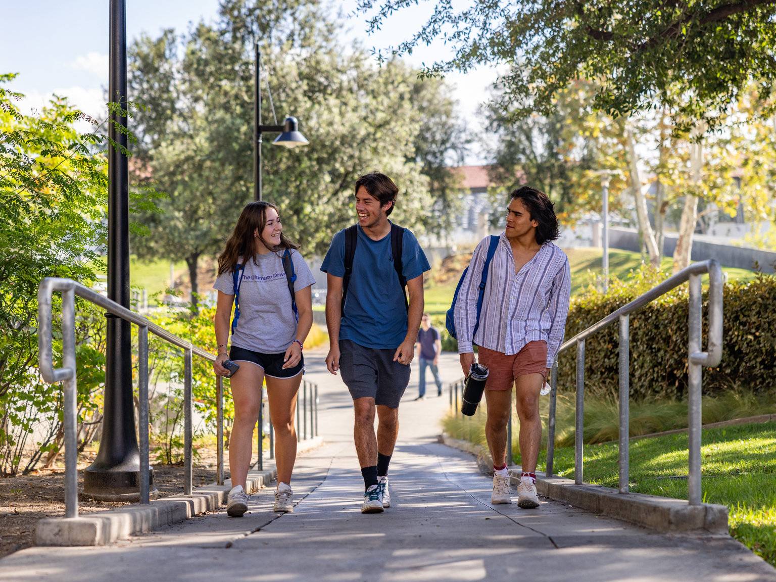 a group of people walking down a sidewalk