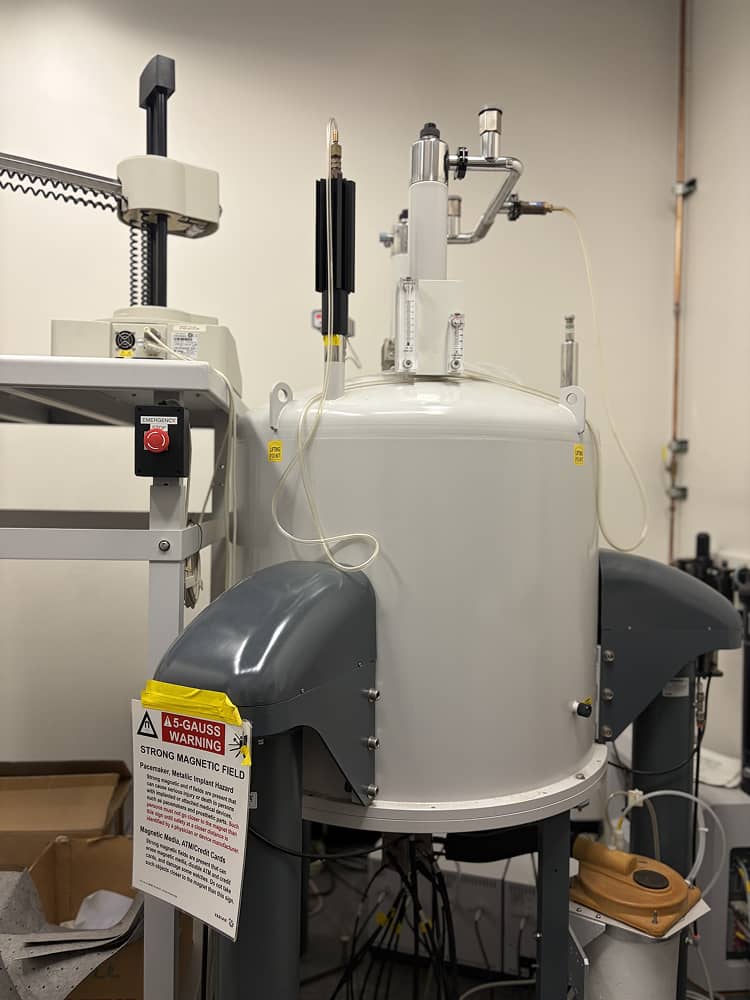 a white machine with black handles and a white sign