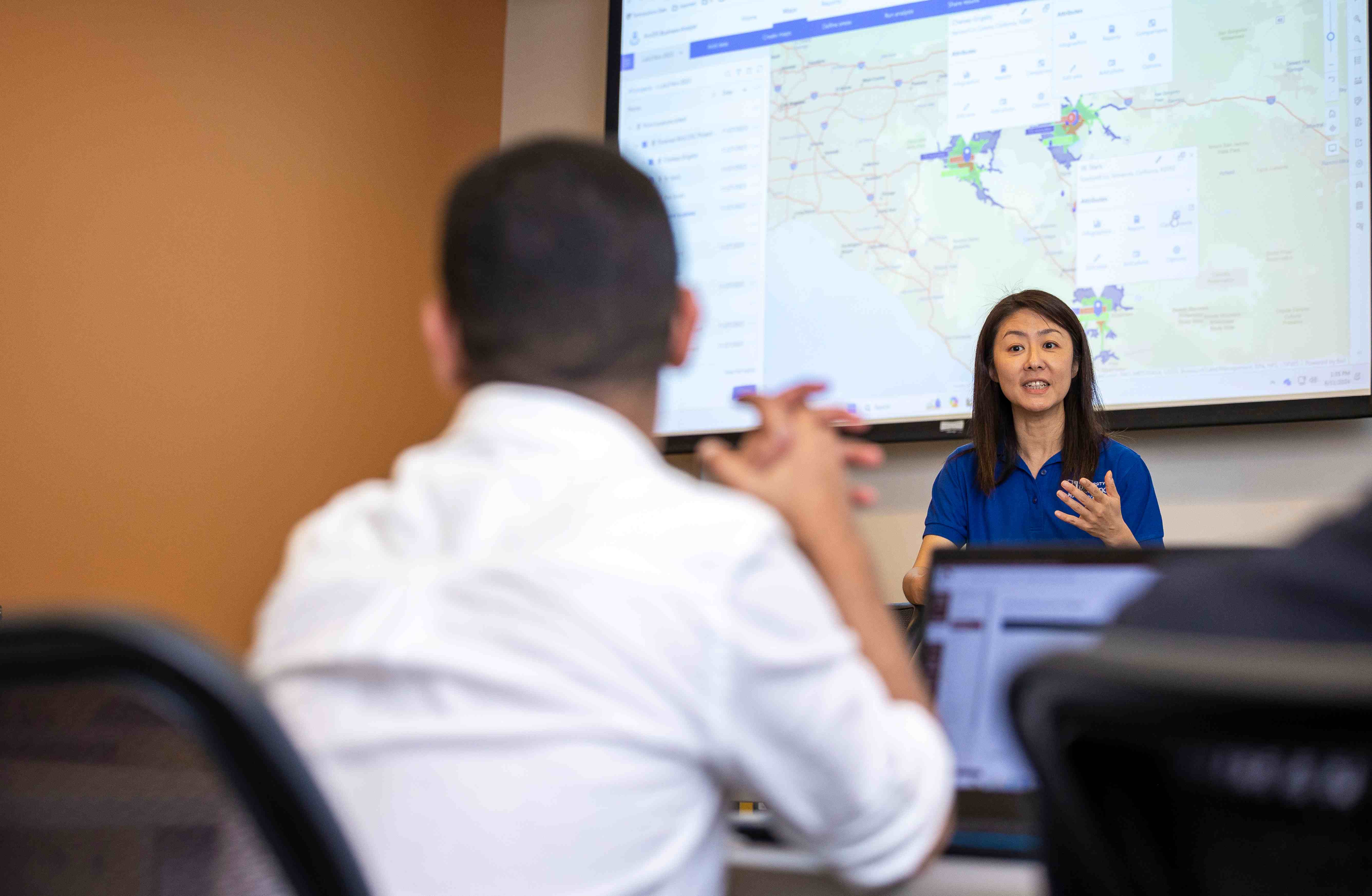 a woman in front of a screen