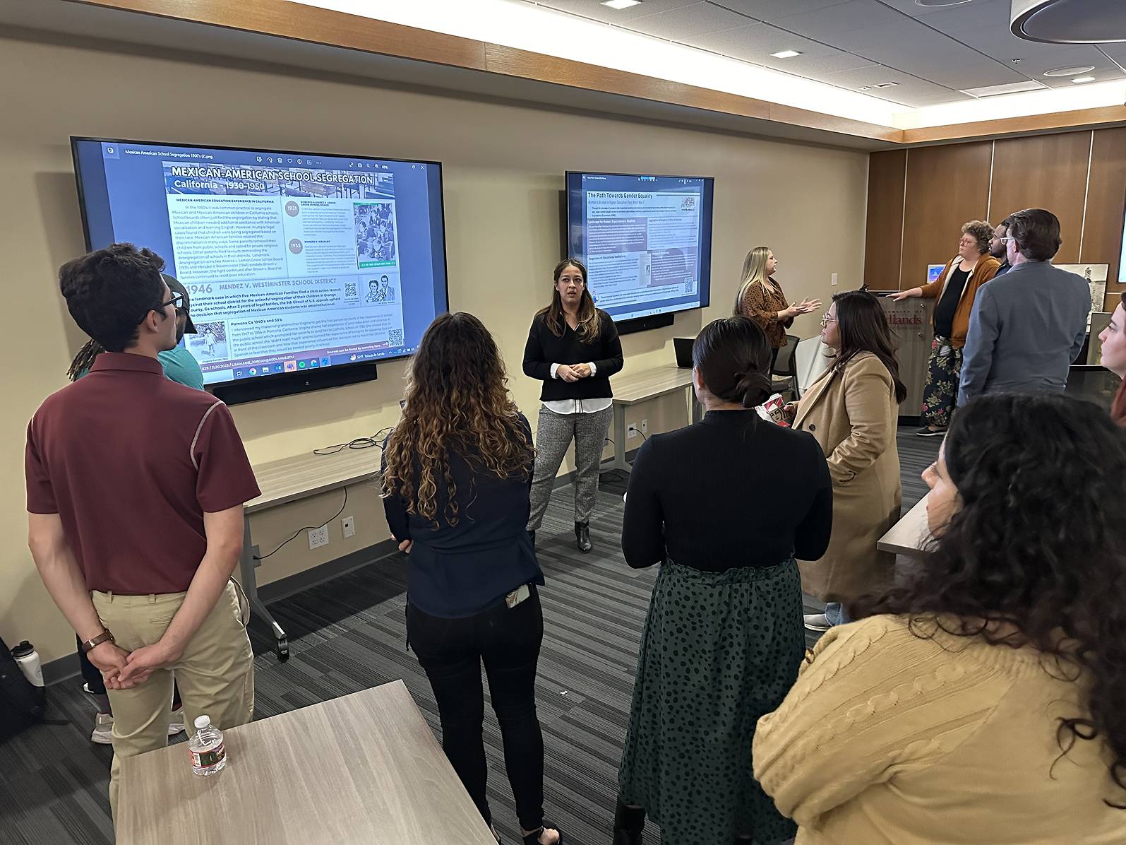 a group of people standing in front of a screen