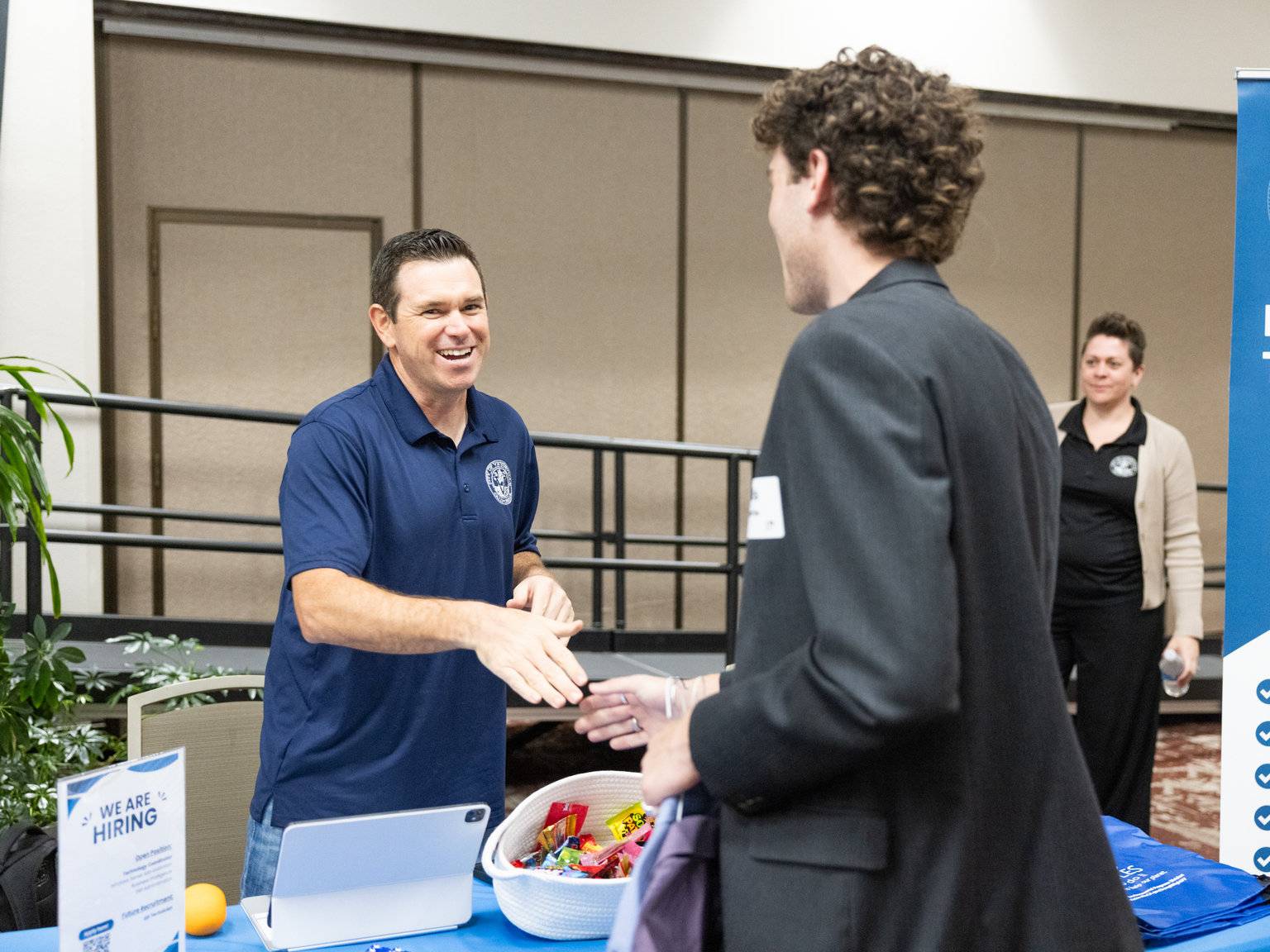 a man handing a hand to another man