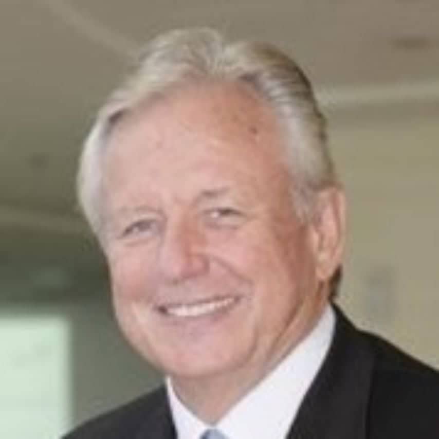 a man in a suit smiling