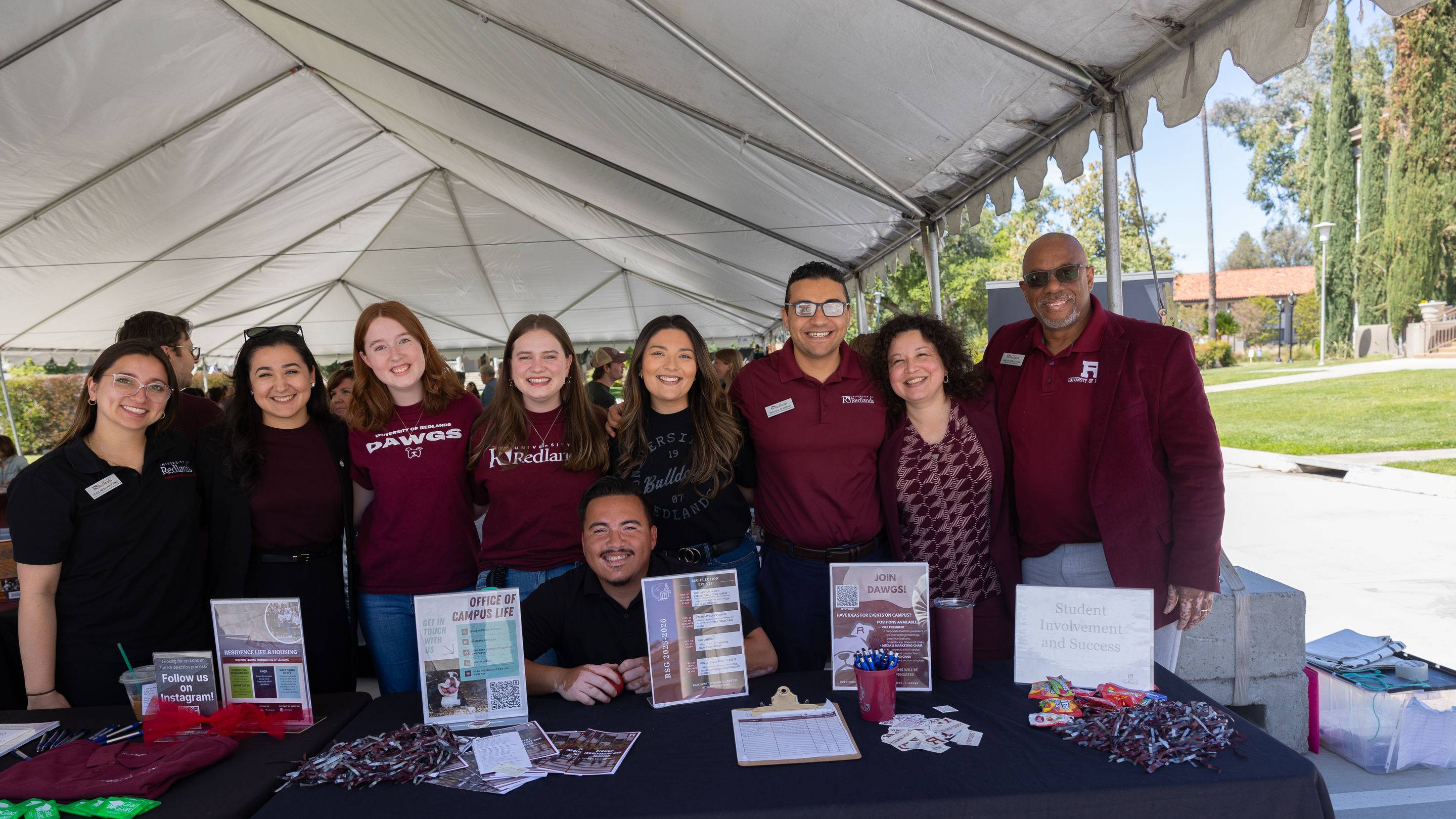 a group of people standing under a tent