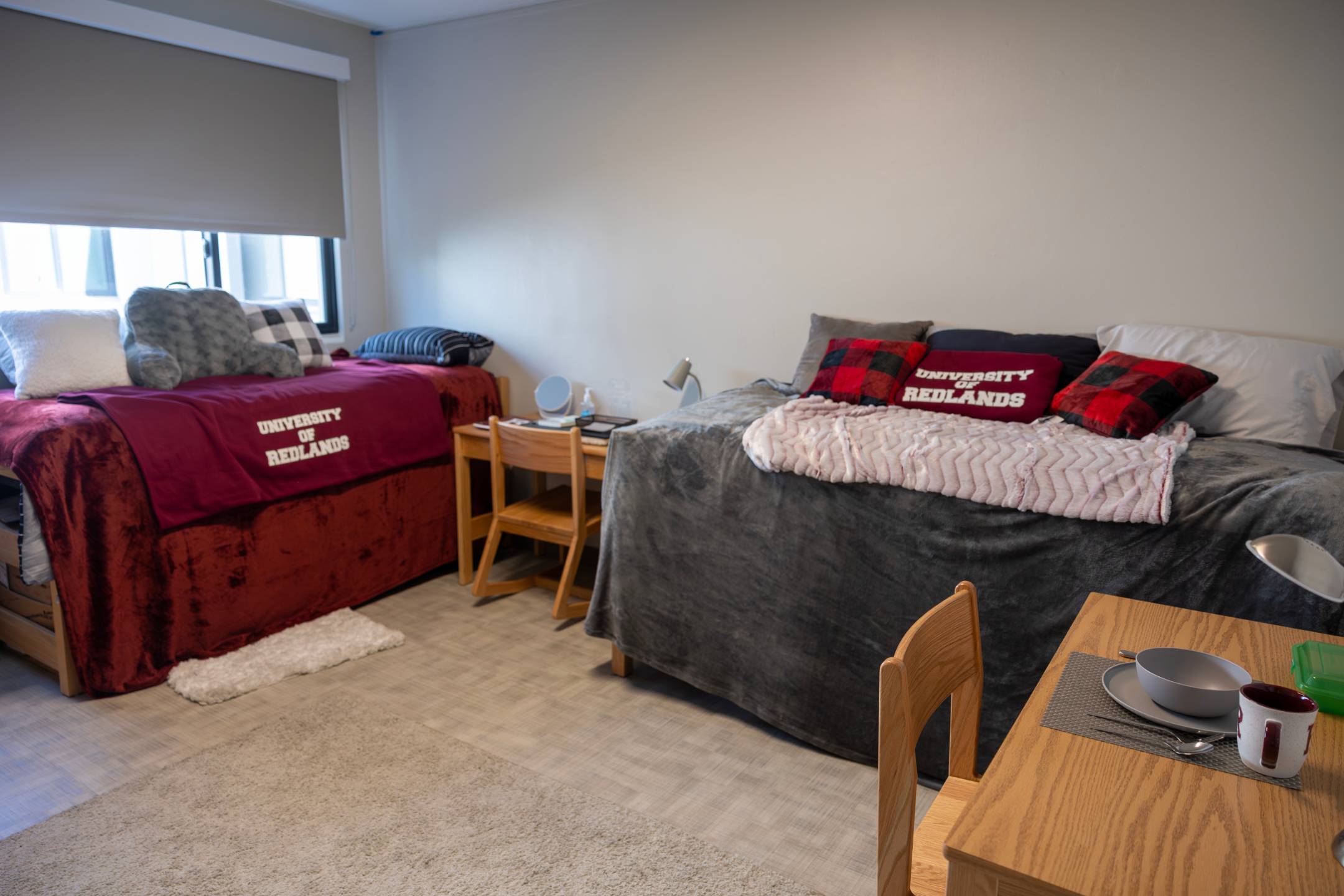 a room with two beds and a table