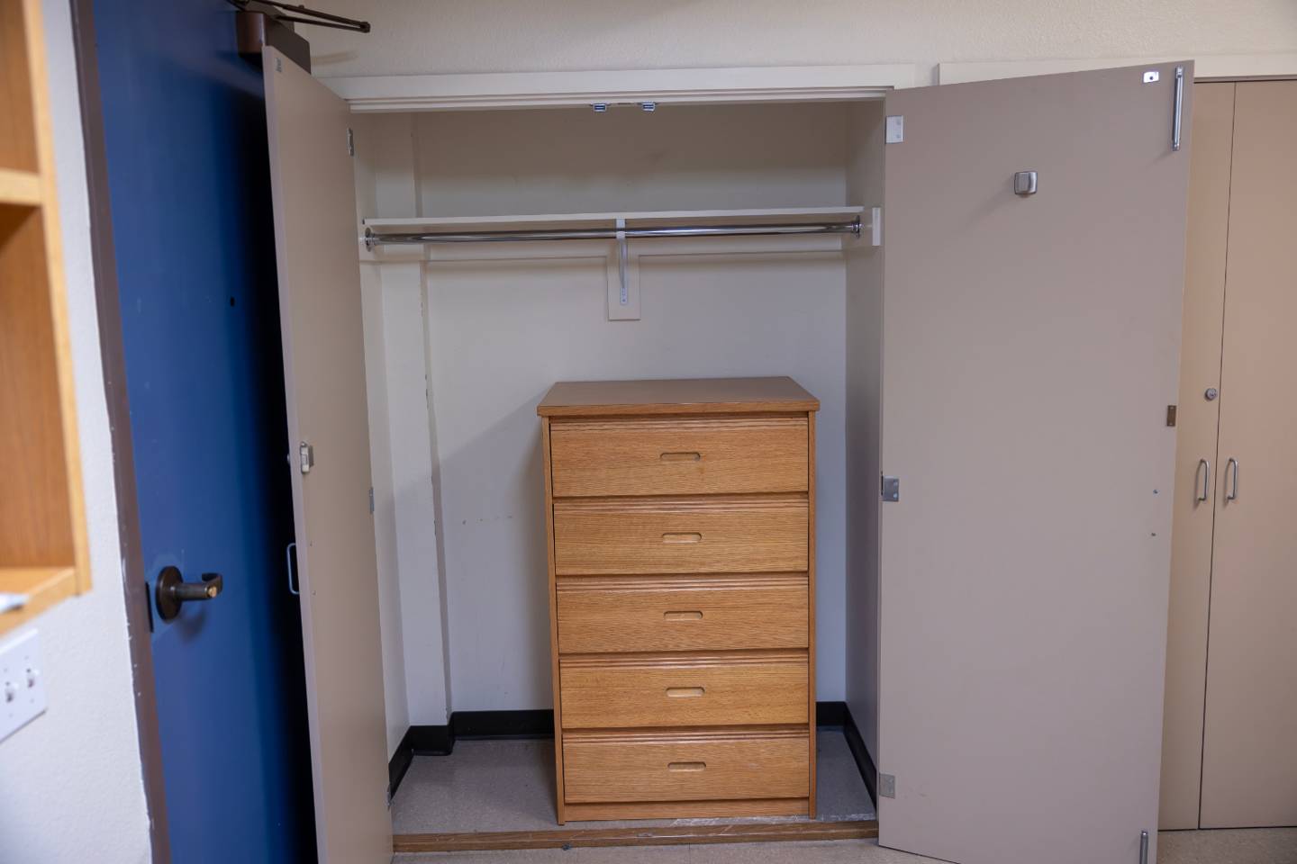 a closet with a drawer and a swinger