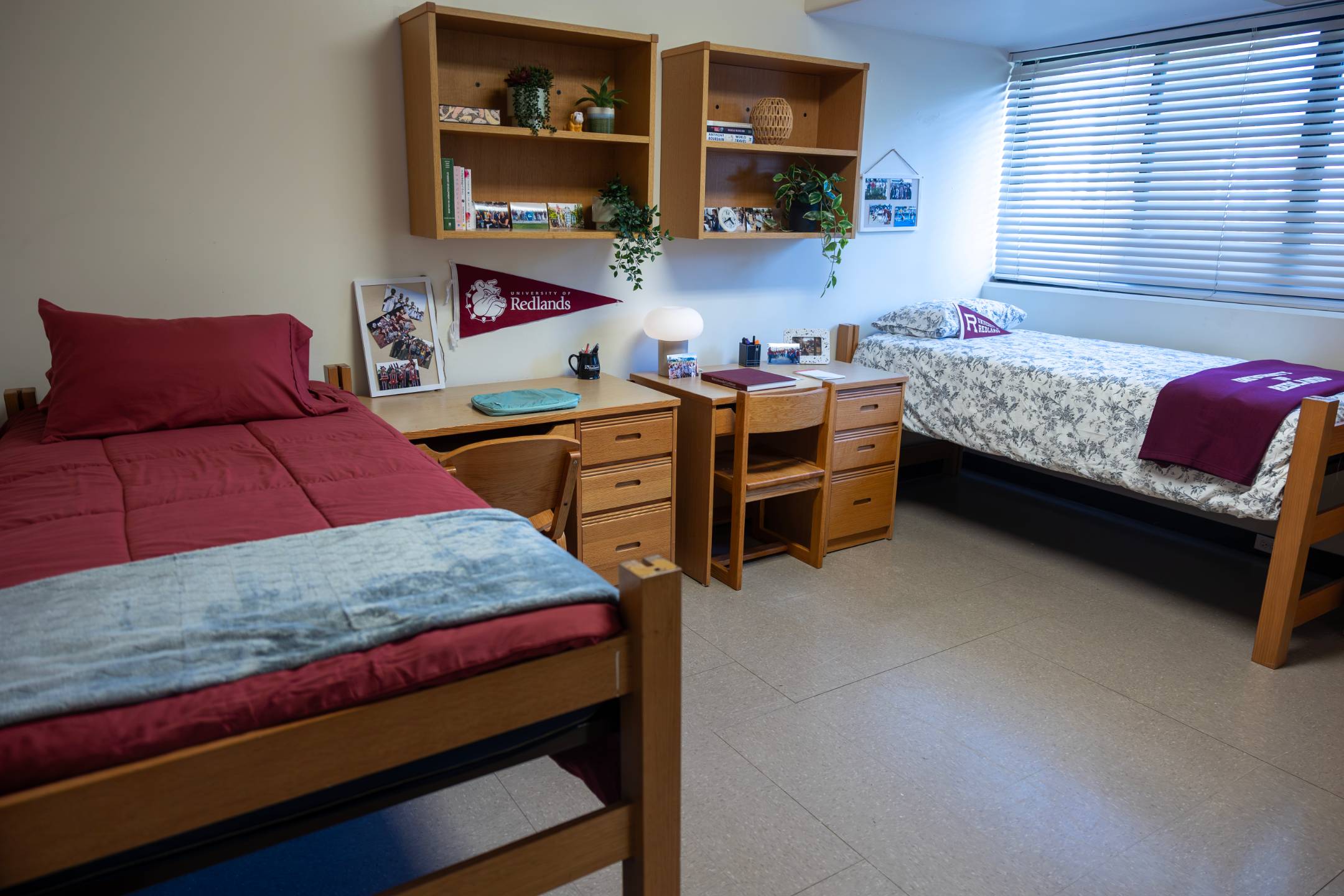 a room with two beds and desks