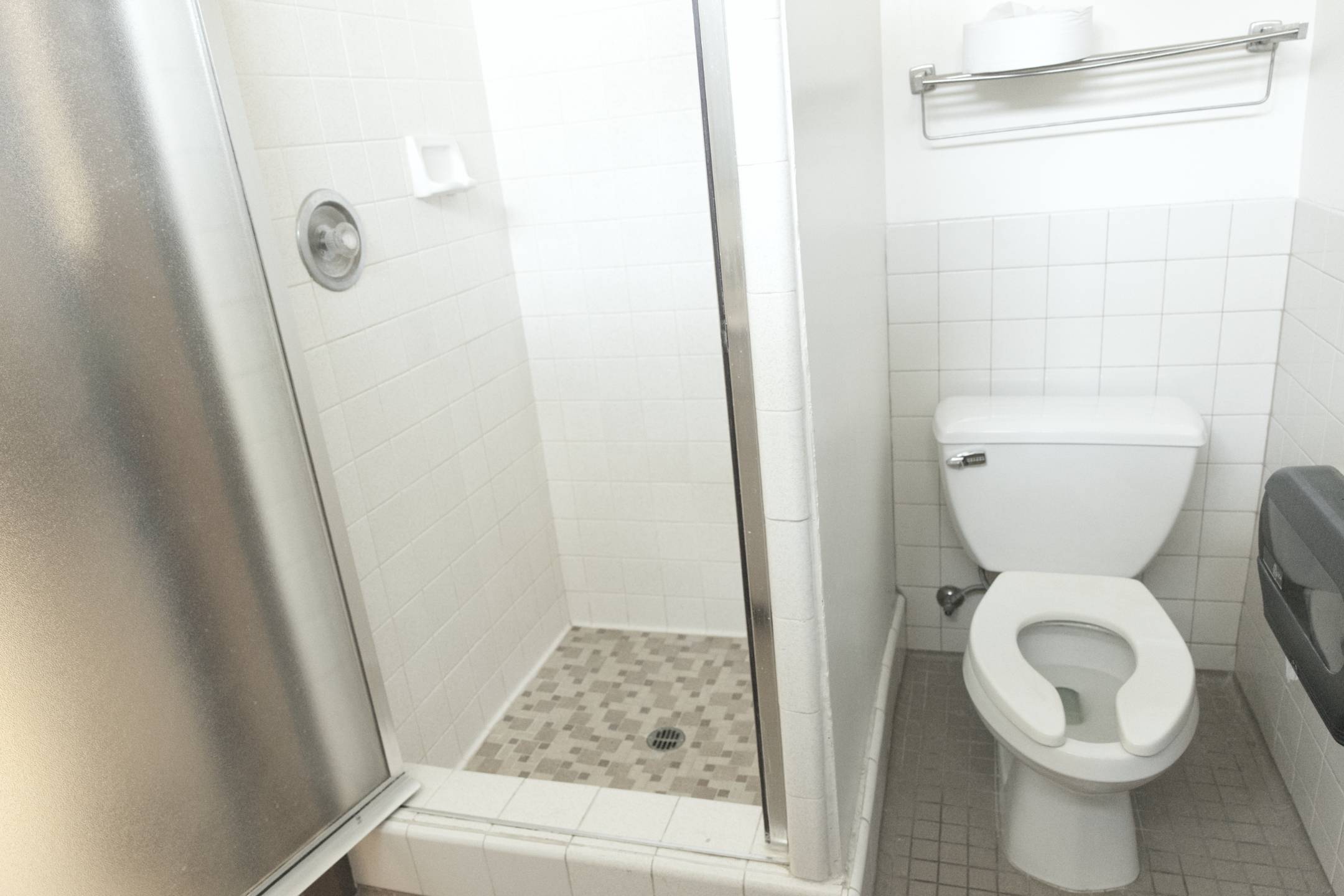 a bathroom with a shower and toilet
