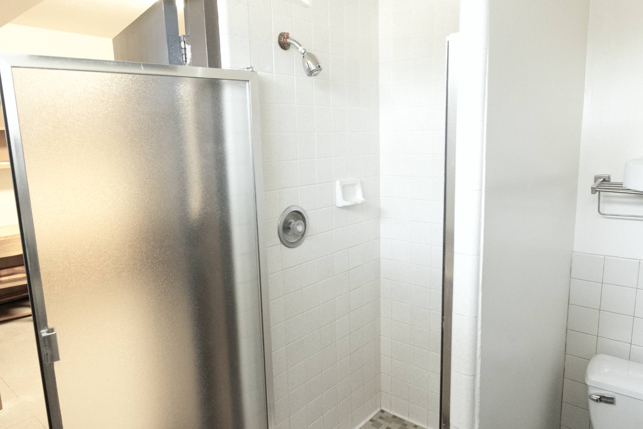 a shower with a silver shower head