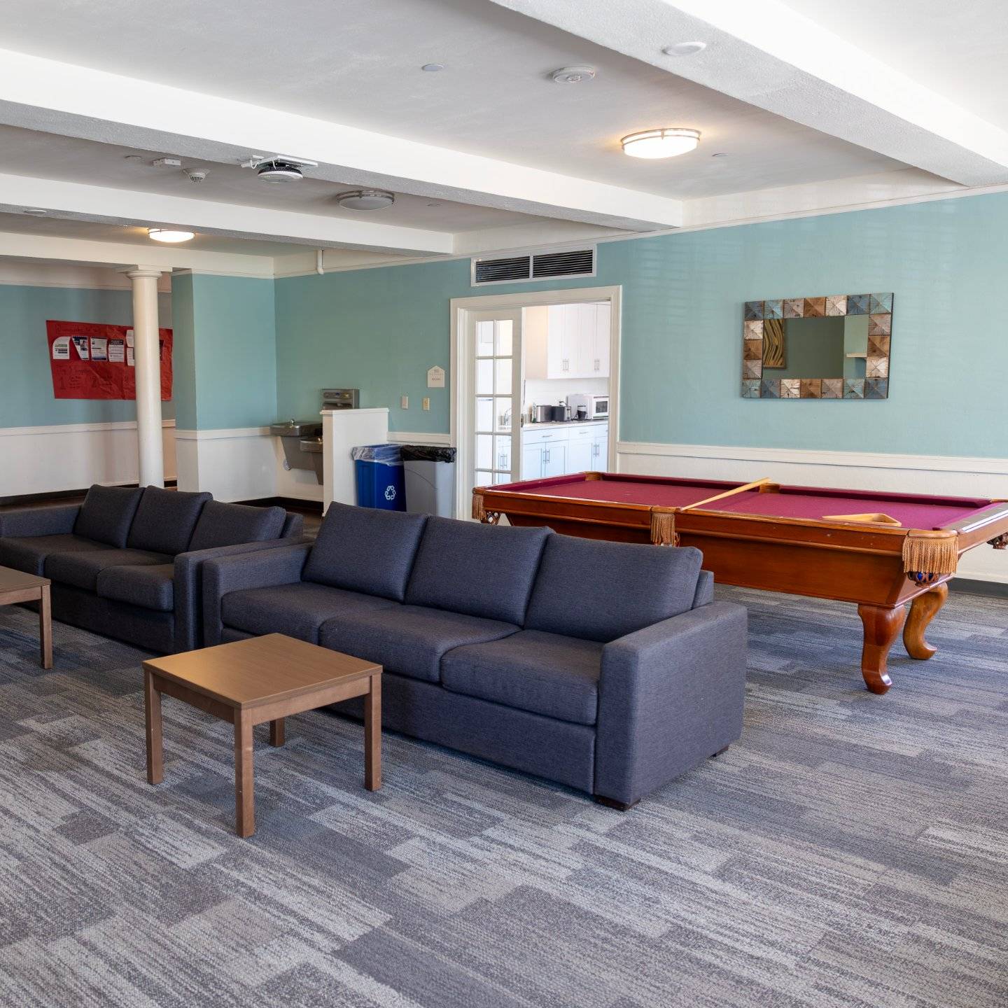 a pool table and couches in a room