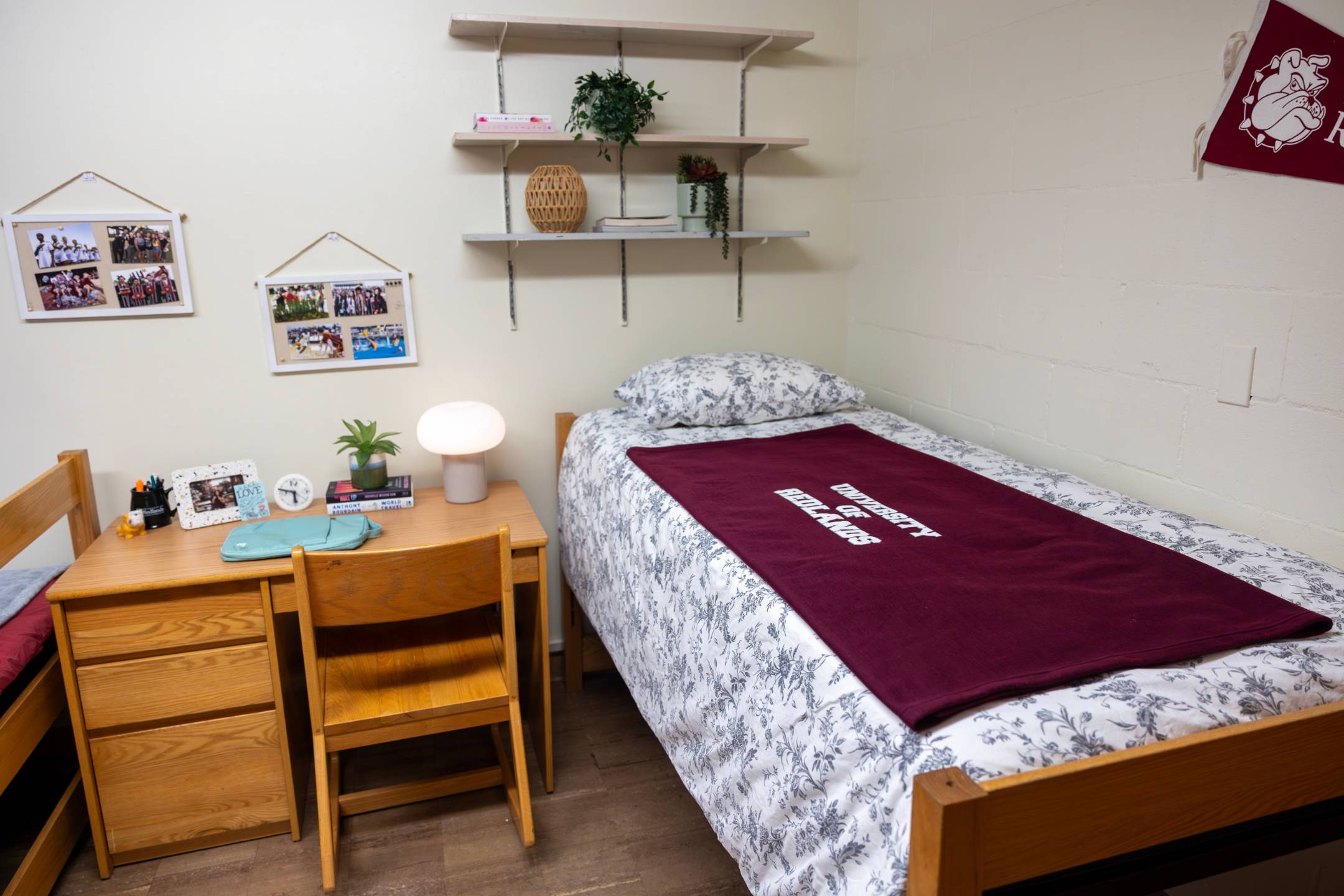 a small room with a bed and desk