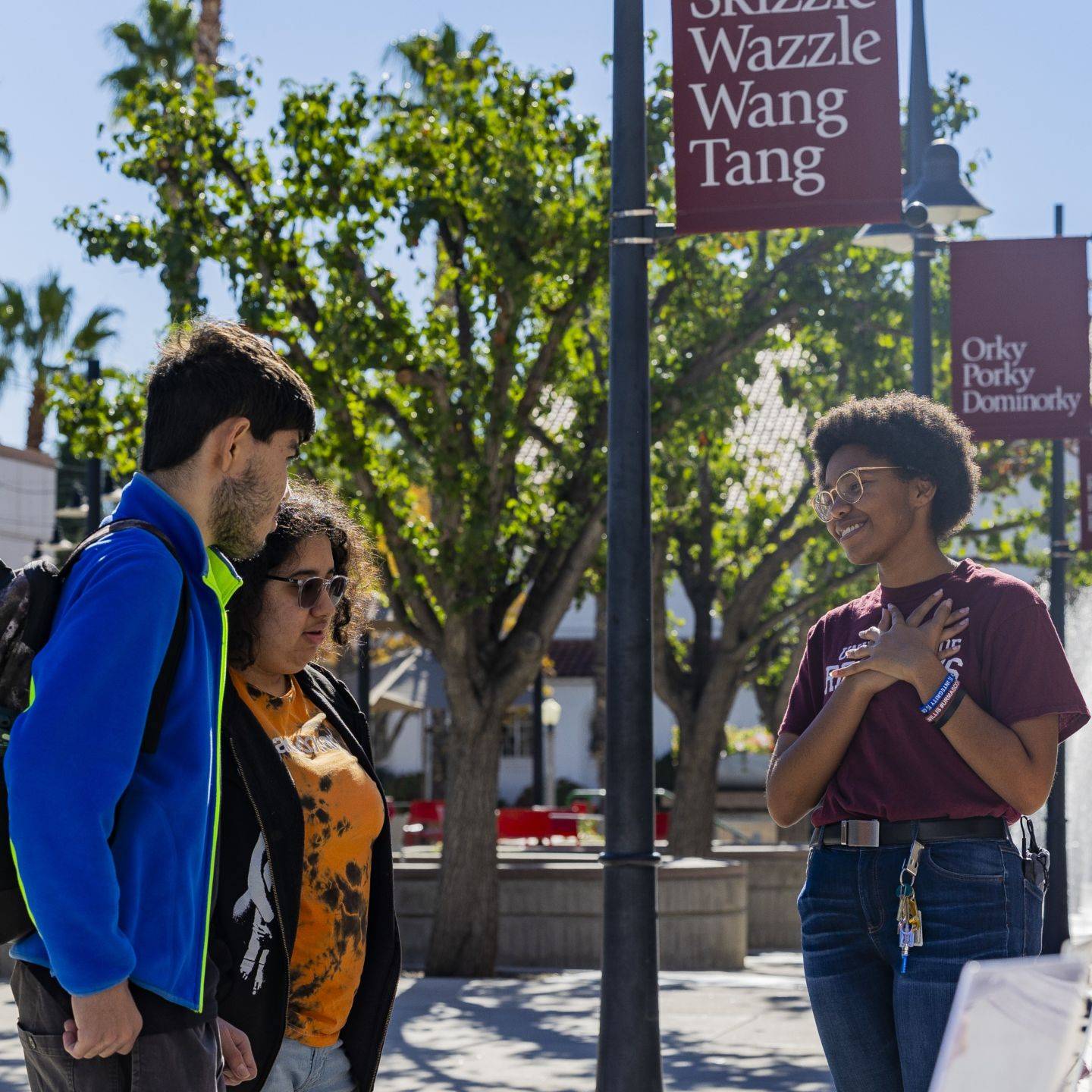 a group of people standing on a sidewalk