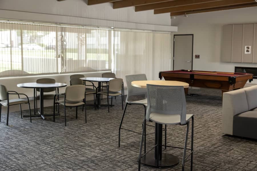 a room with tables and pool table