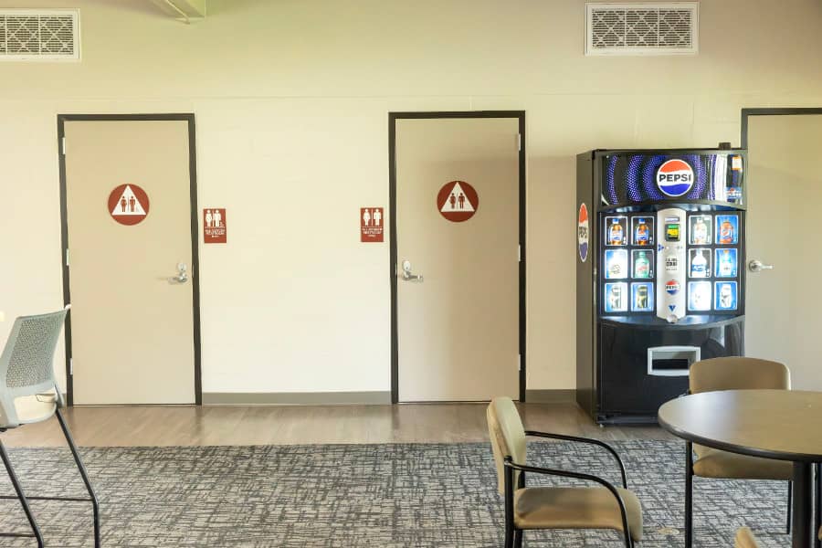 a room with a vending machine and a chair