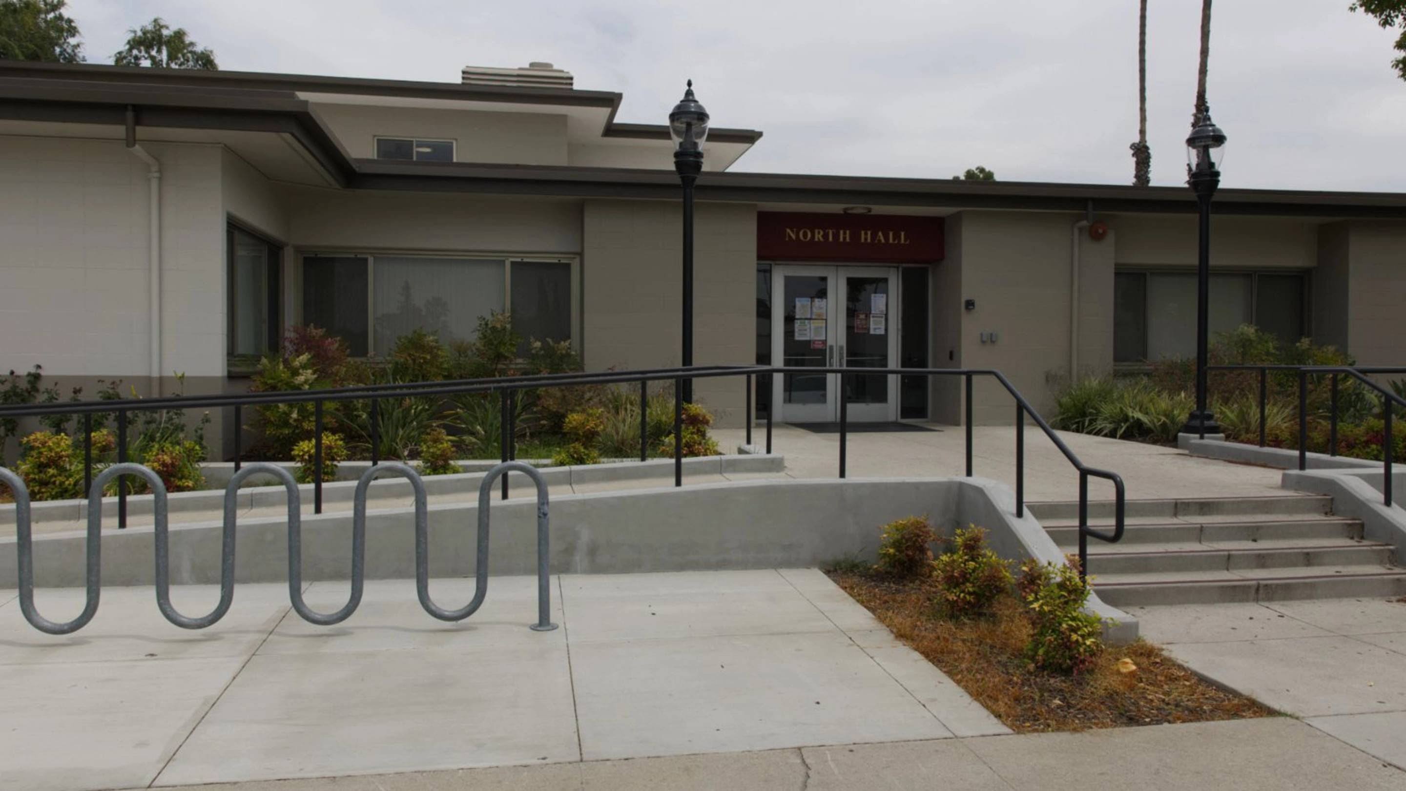 a building with a railing and a lamp post