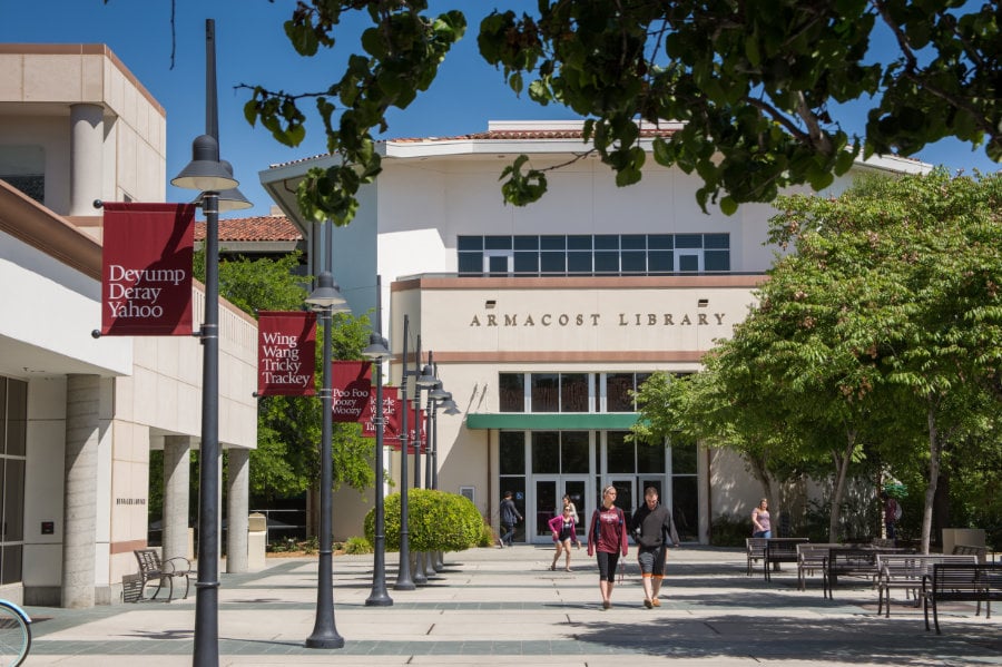 people walking in front of a library