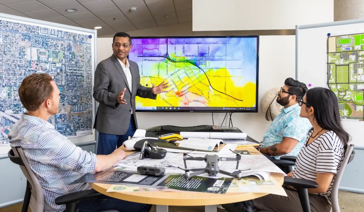 a man standing in front of a large screen