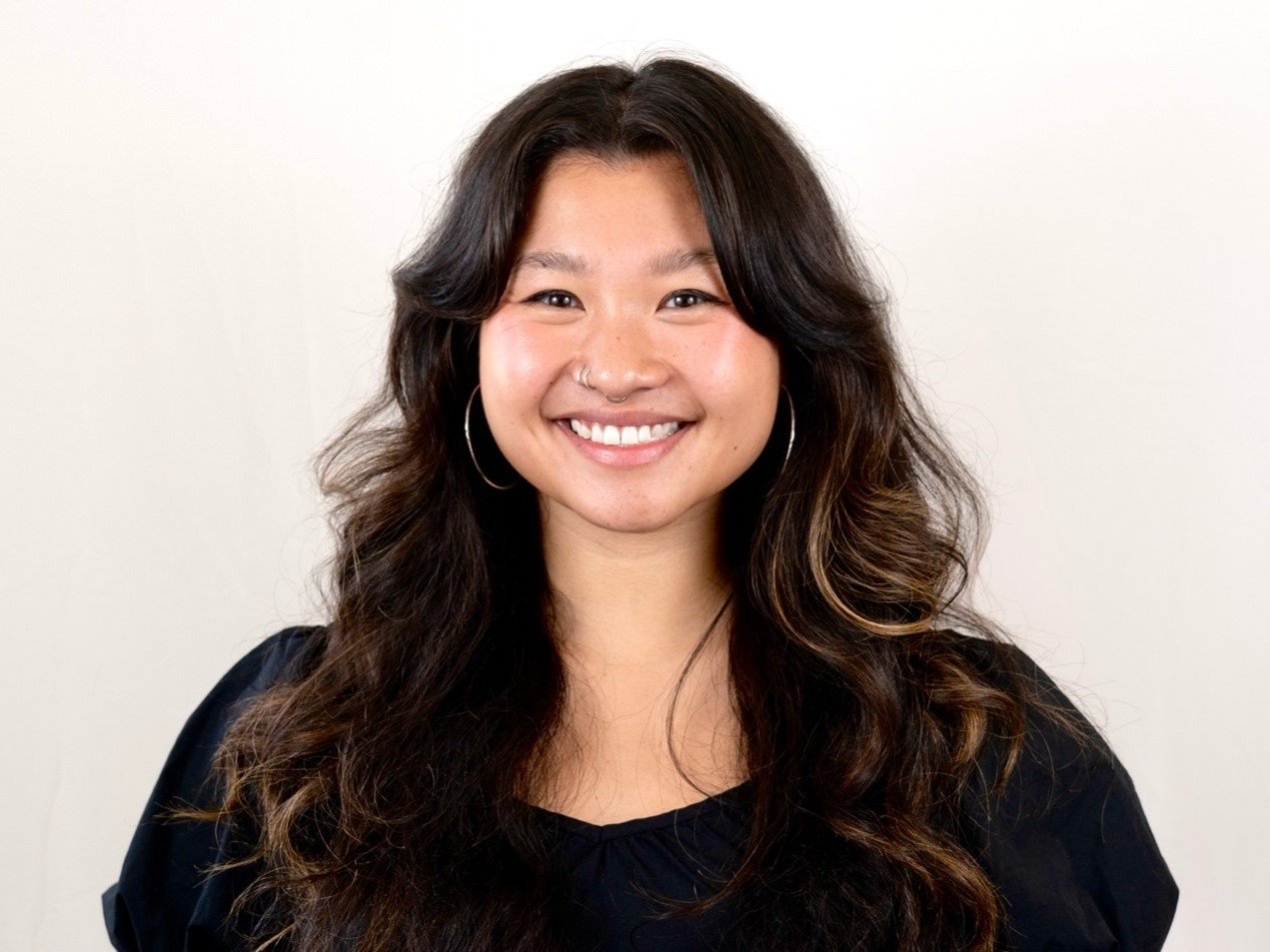 a woman with long hair smiling