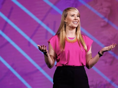 a woman in pink shirt and black pants