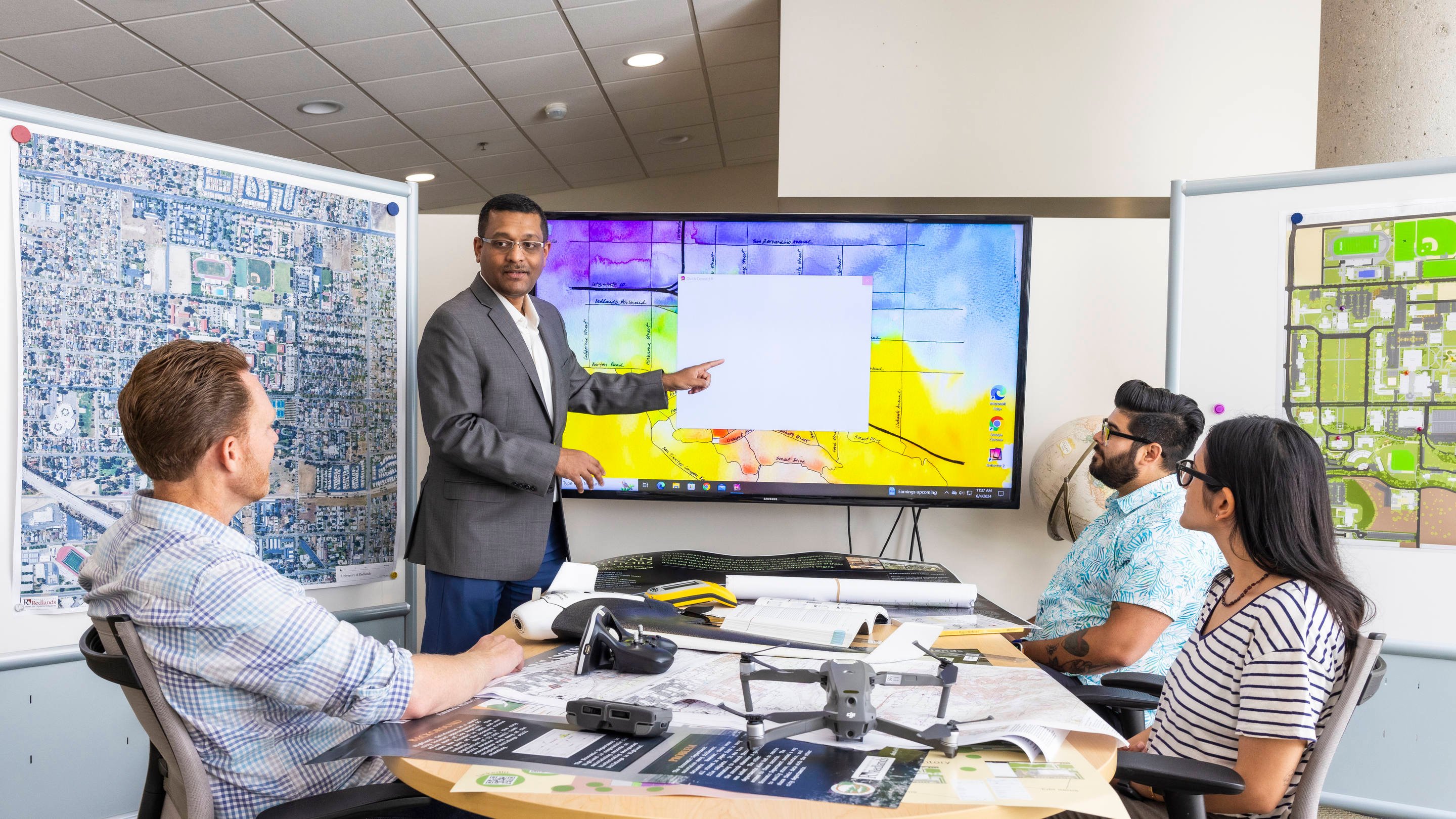 a man pointing at a screen