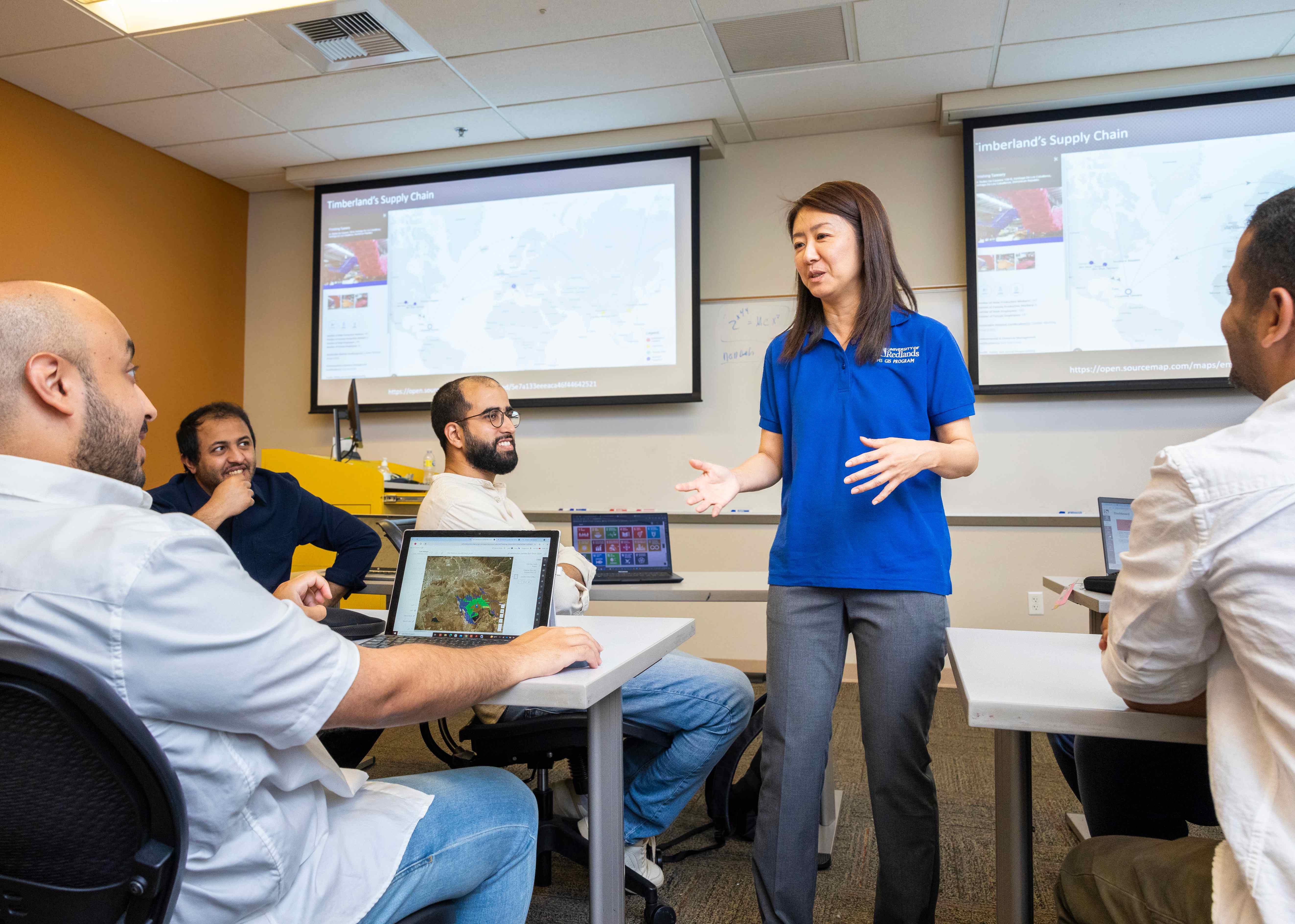 a woman standing in front of a group of people