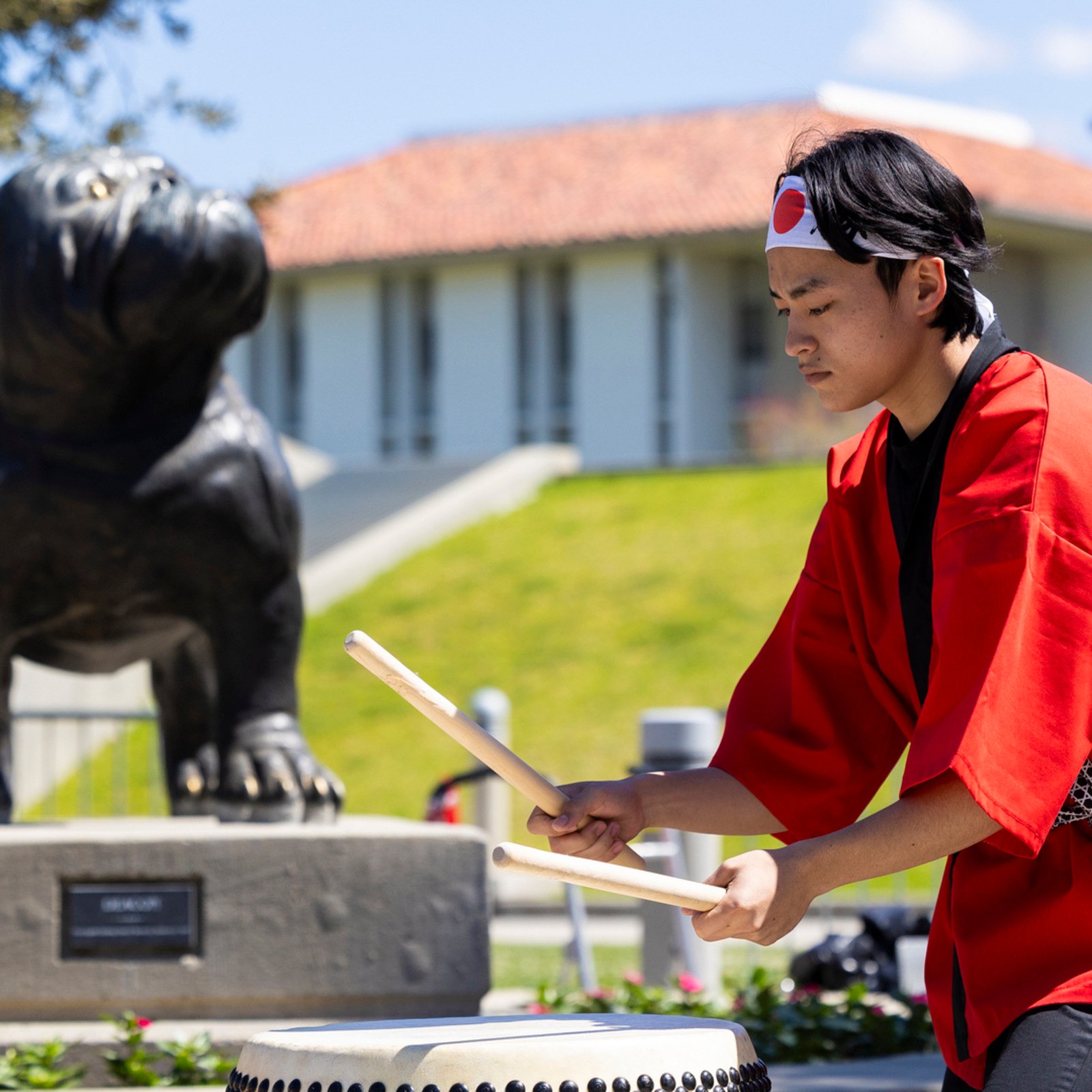 a man playing drums outside