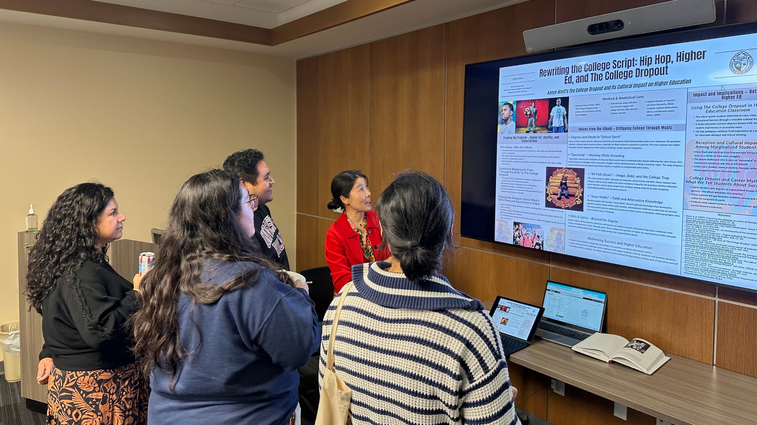 a group of people standing in front of a screen