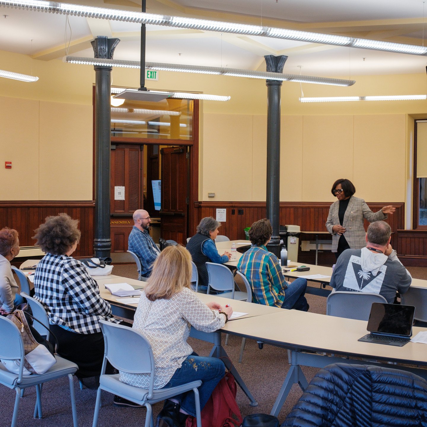 a group of people sitting at tables in a room