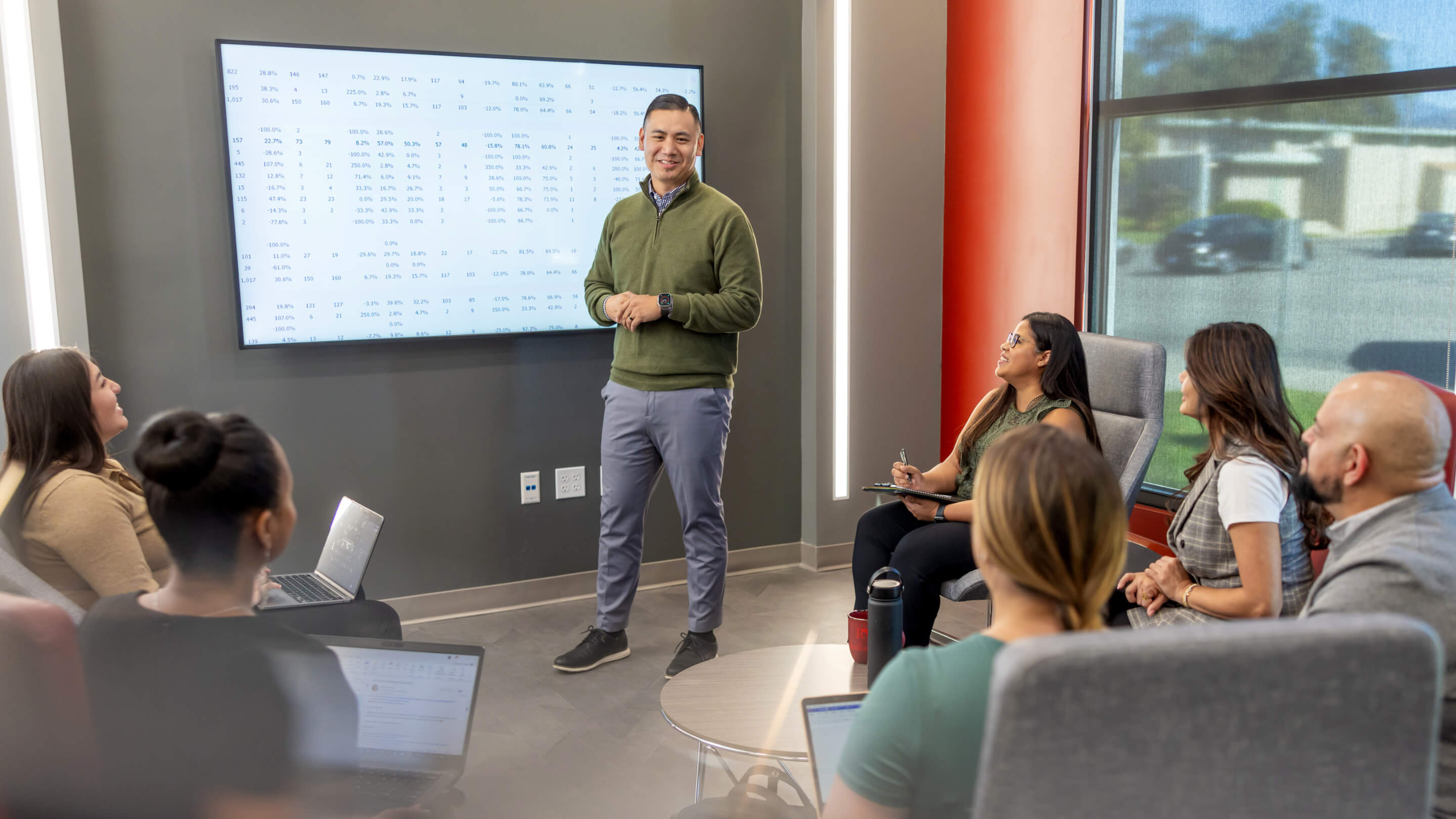 a man standing in front of a screen