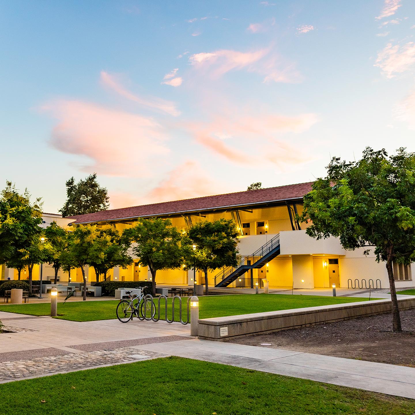 a building with trees and a walkway
