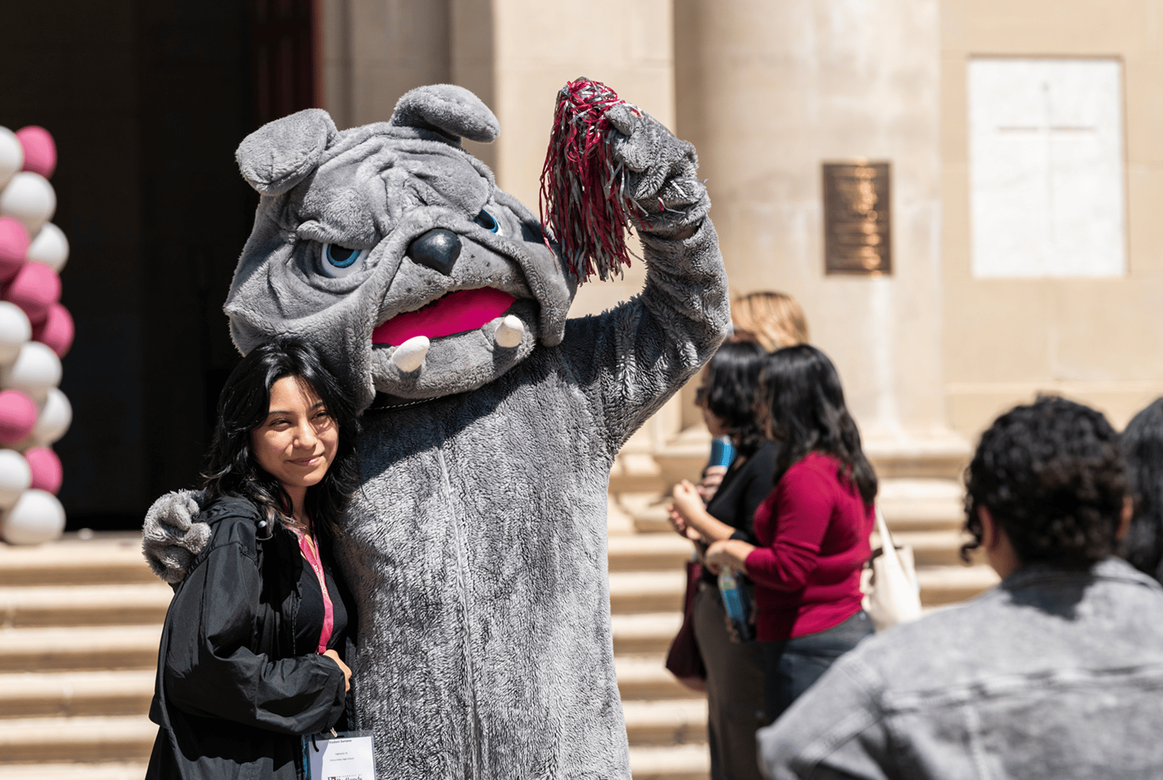 a person in a mascot garment posing with a woman