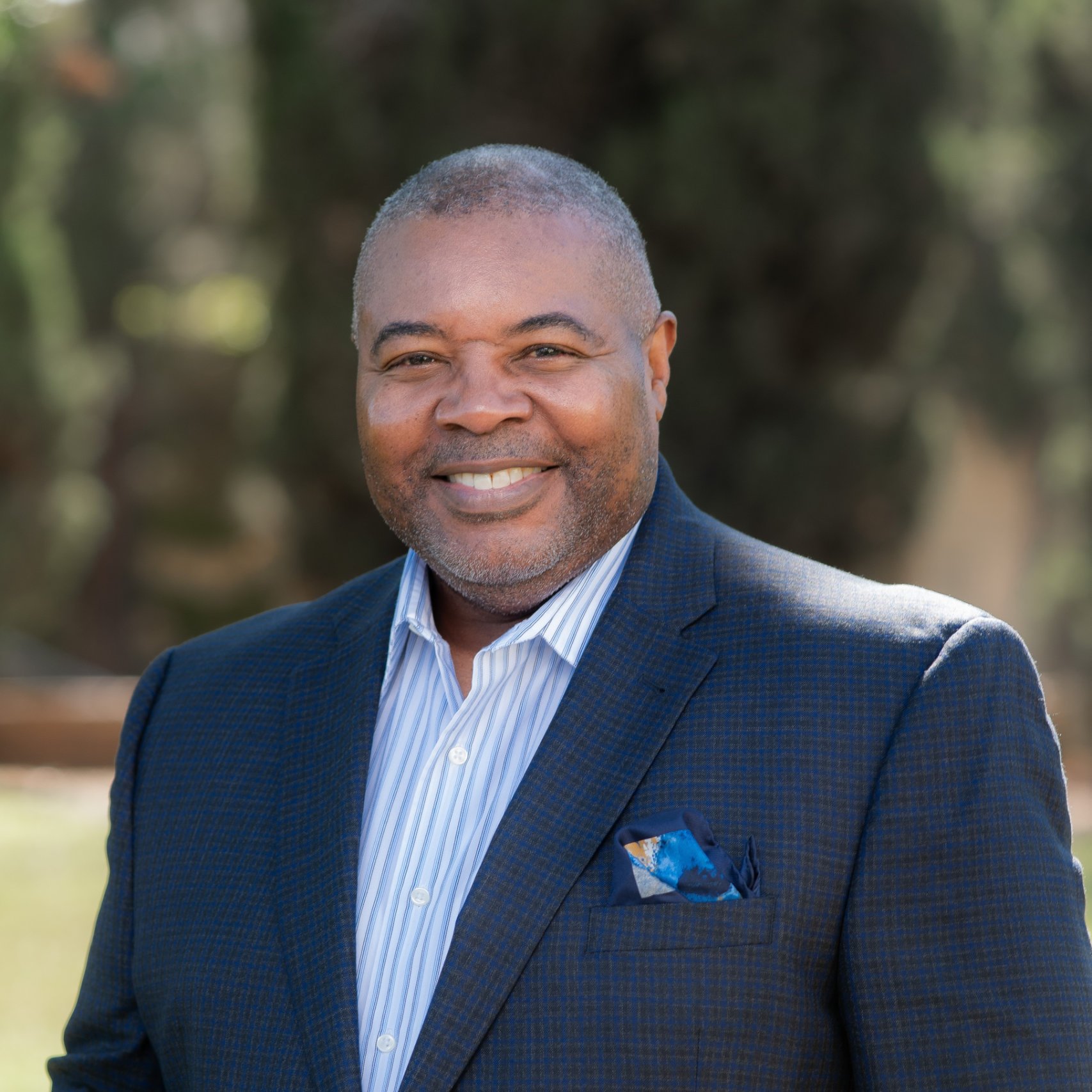 a man in a suit smiling