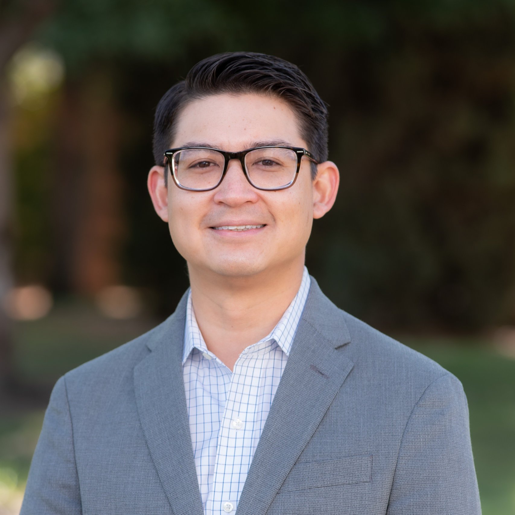 a man wearing glasses and a suit