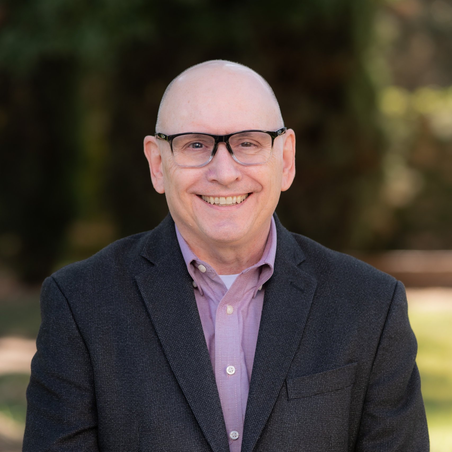 a man wearing glasses and a suit
