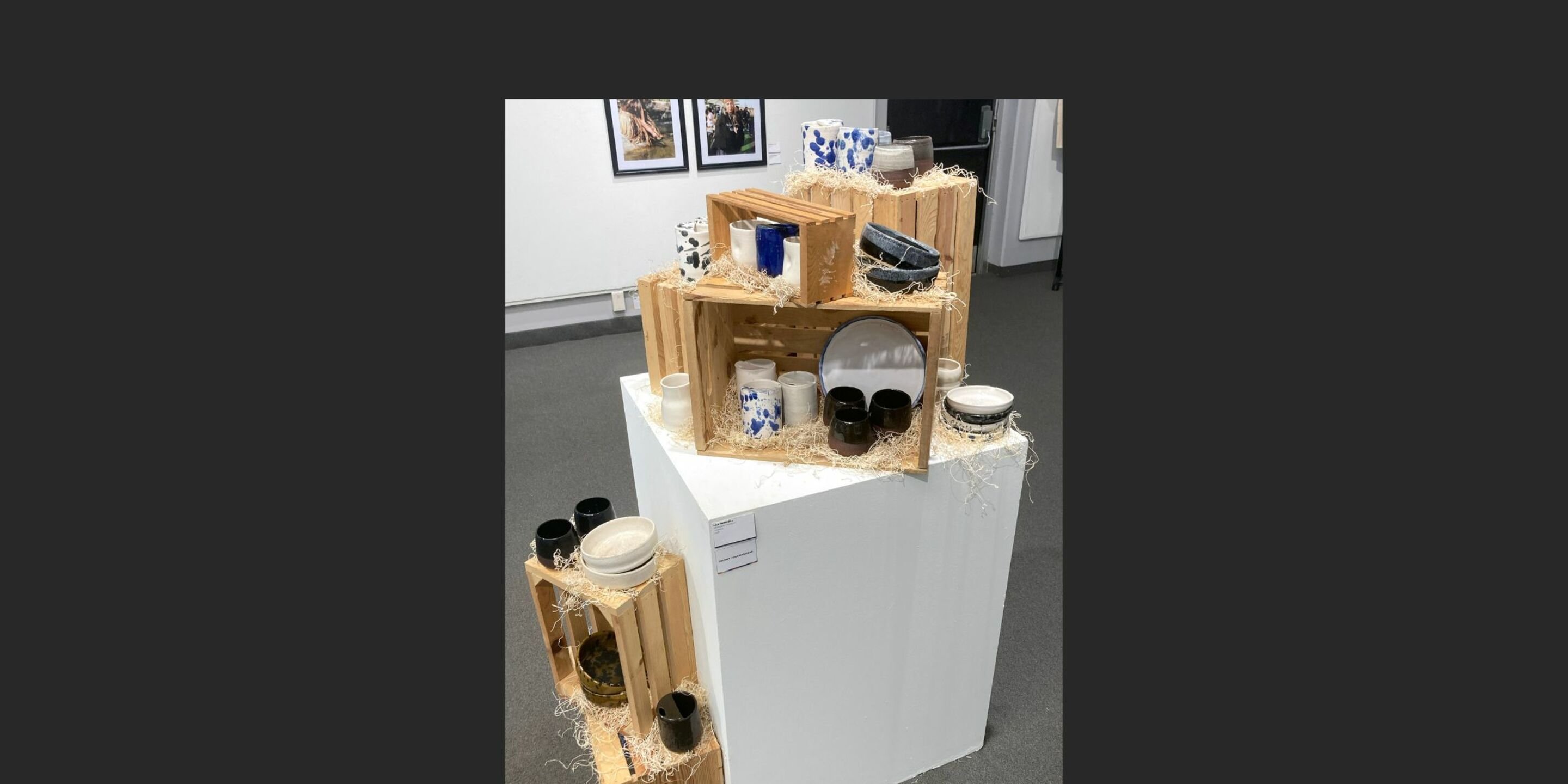 a display of wooden crates with different colored objects