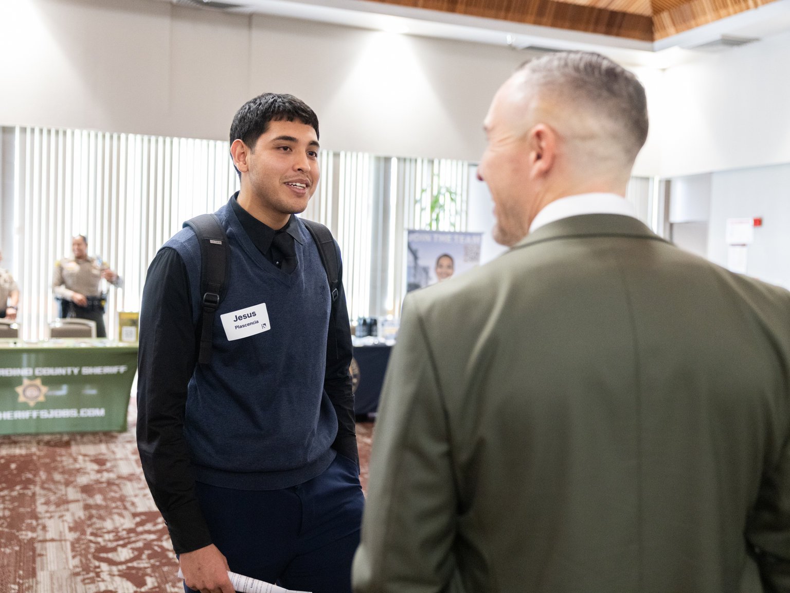 a man talking to another man