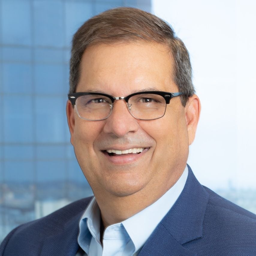 a man wearing glasses and a suit