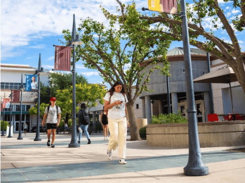 a woman walking on a sidewalk