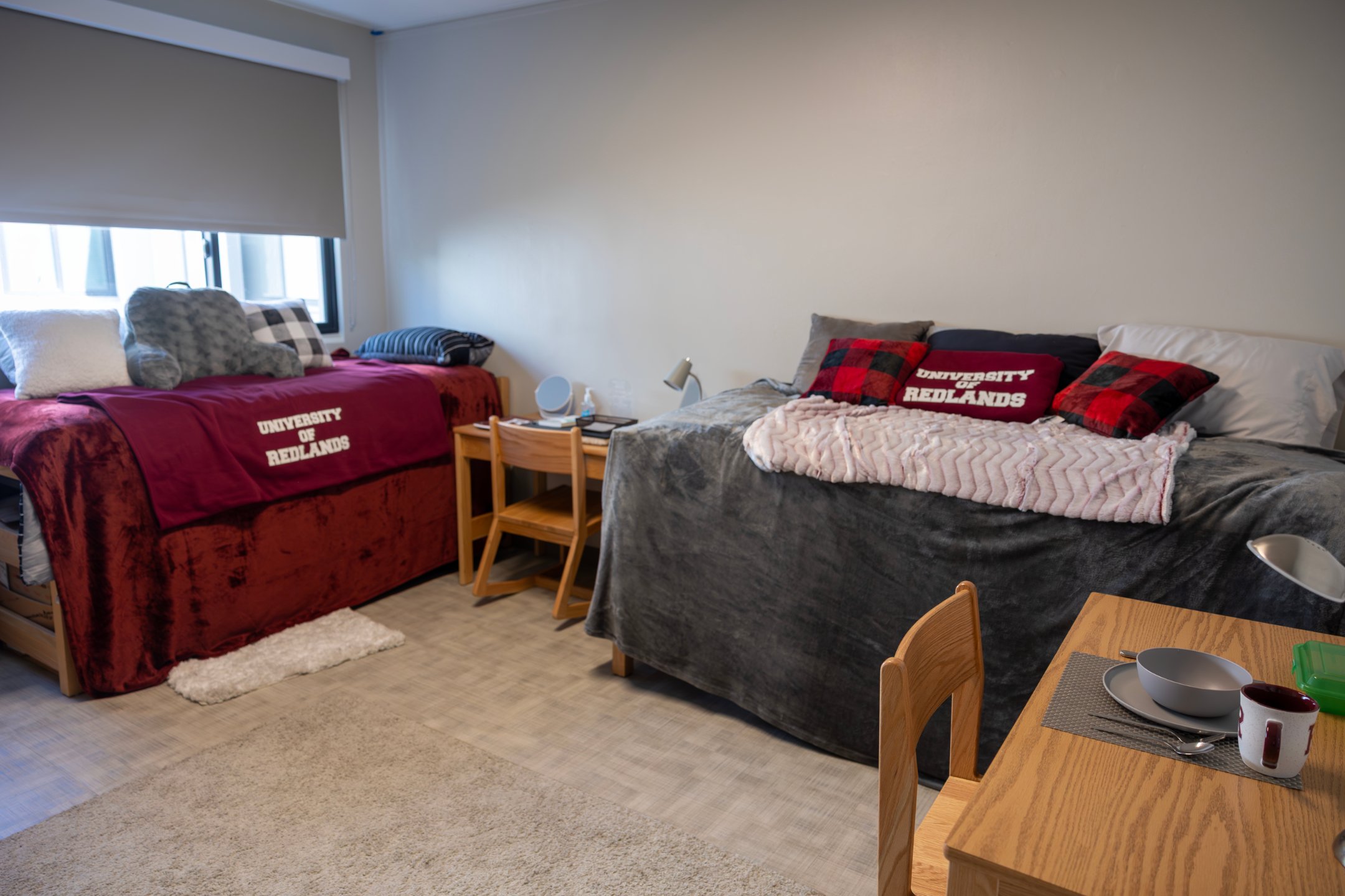 a room with two beds and a table