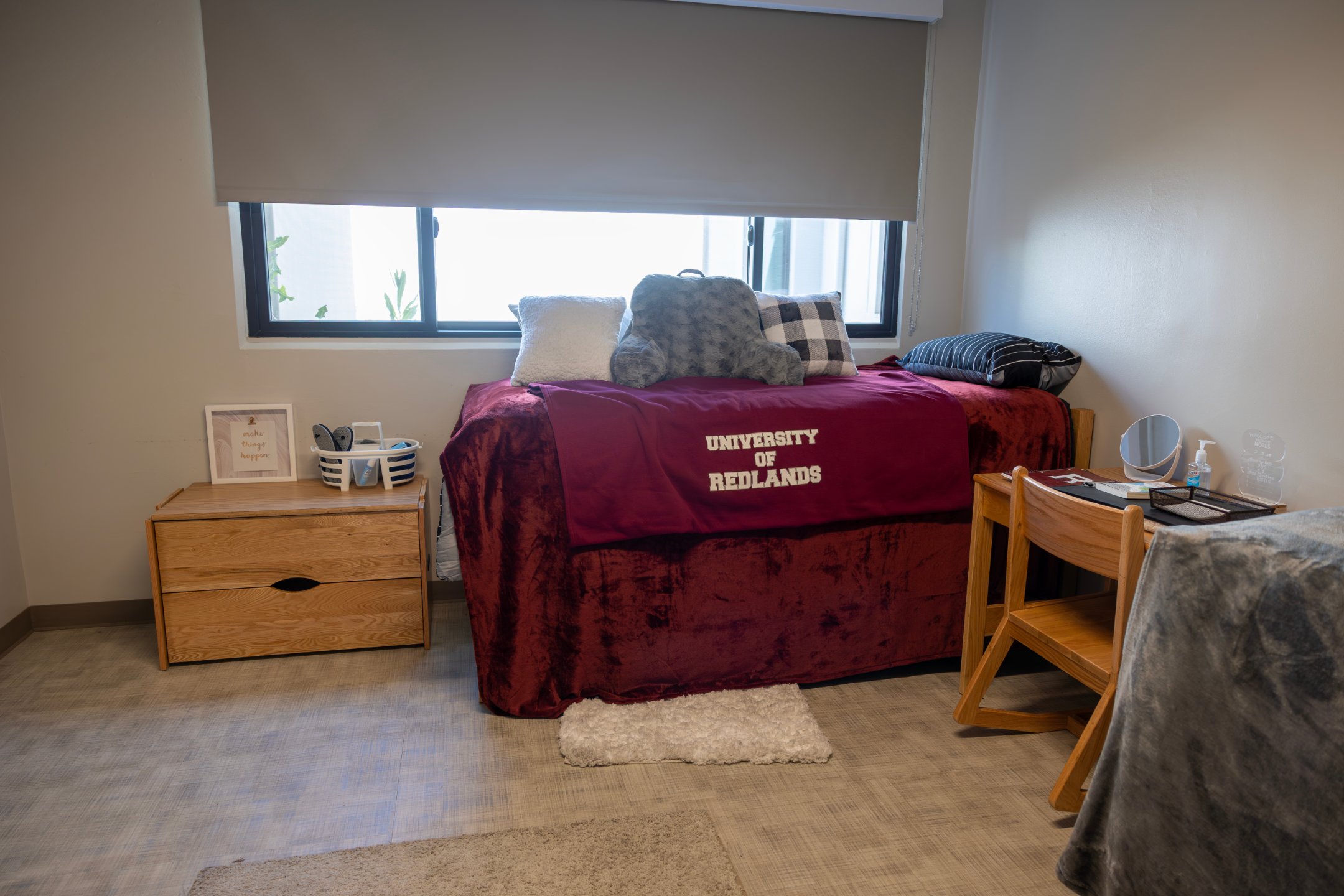 a bed with pillows and a chair in a room