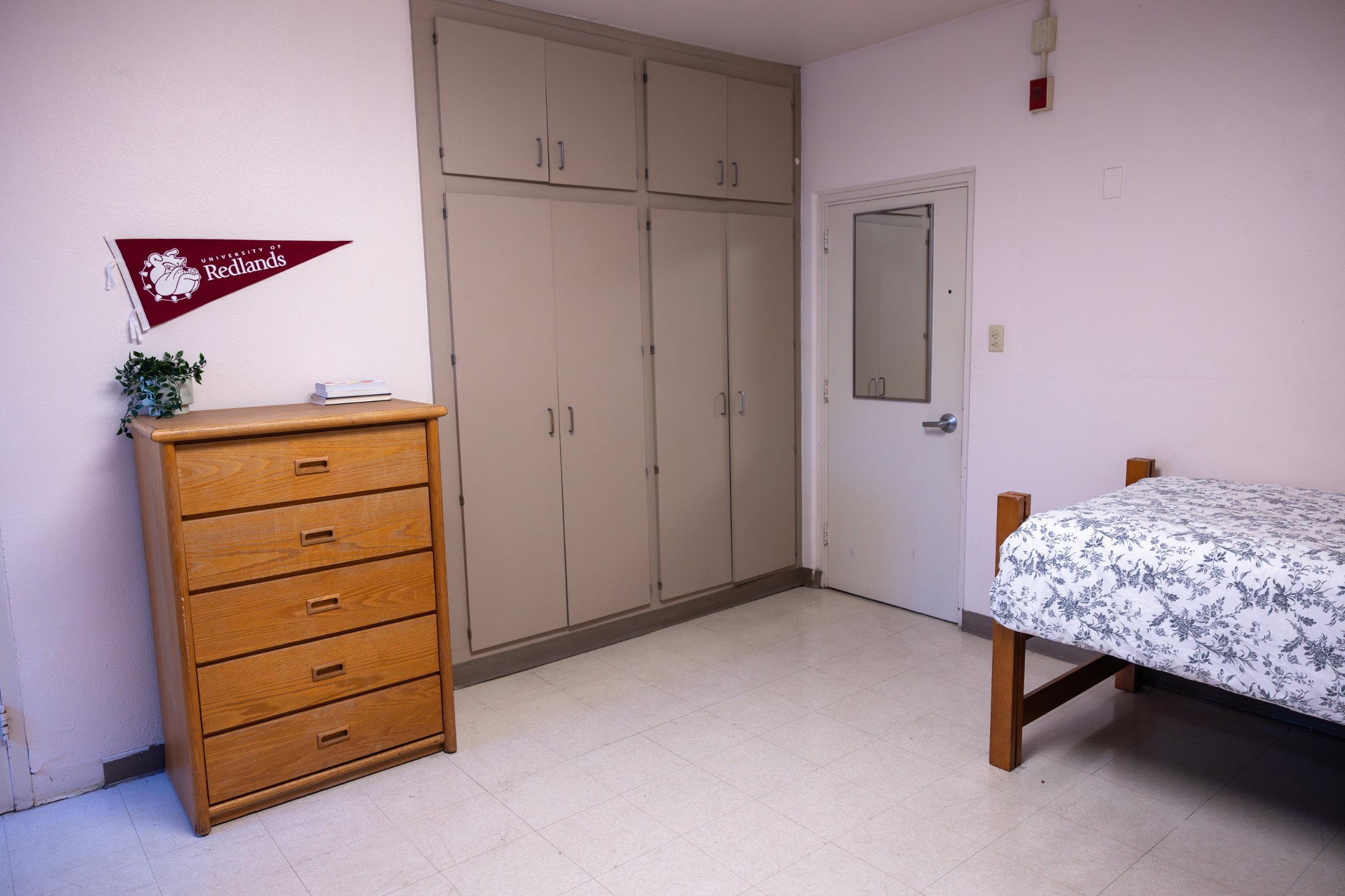 a room with a bed and dresser